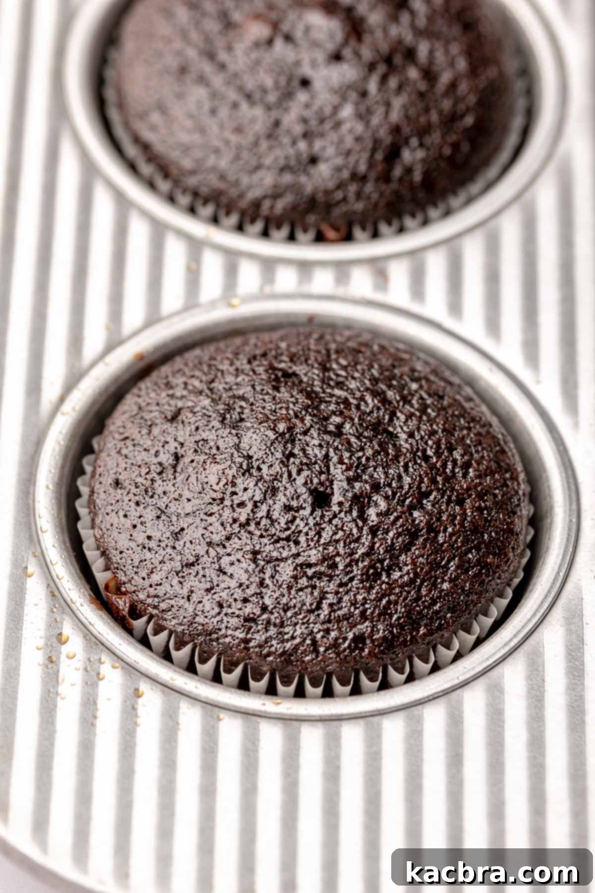 Baked chocolate cupcake in a muffin tin.