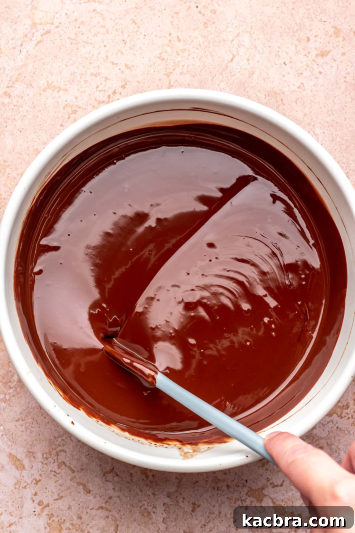 Chocolate ganache cooling to the perfect consistency.