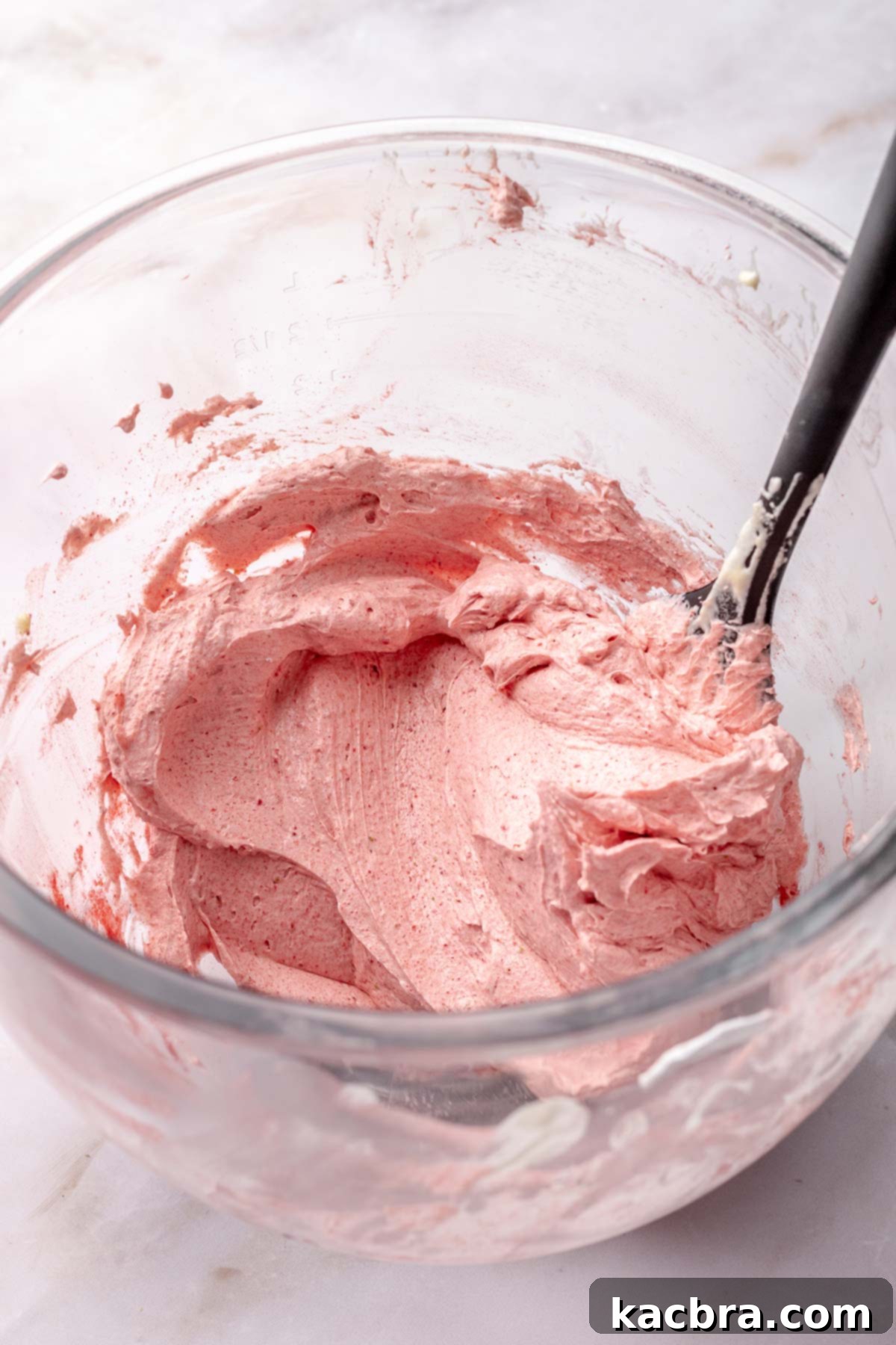 Strawberry swiss meringue buttercream in a bowl.