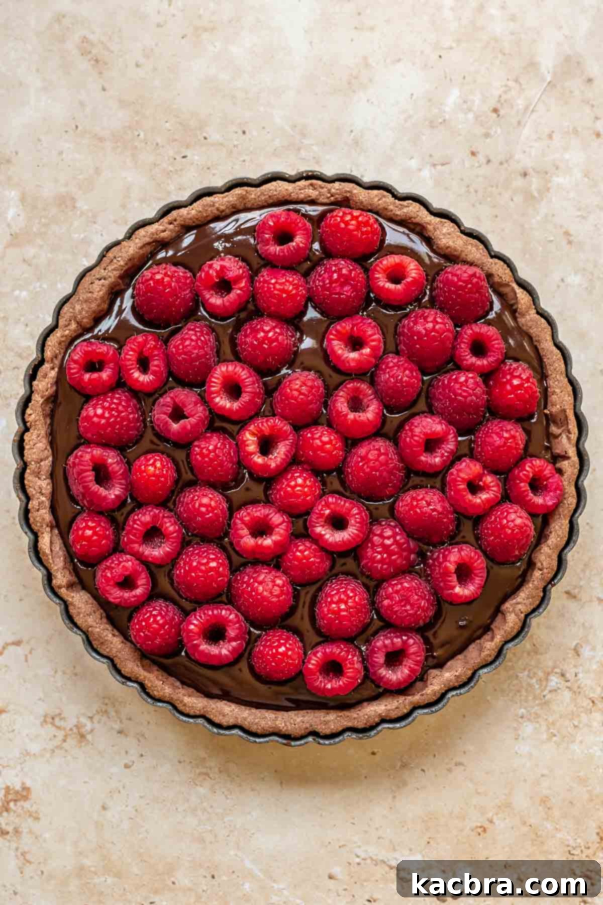 Decadent Chocolate Raspberry Delight 9 Raspberries pressed into chocolate ganache in a tart.