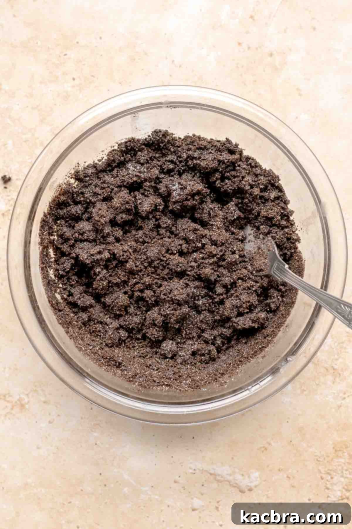 Oreo crumb base mixed in a bowl with a fork.