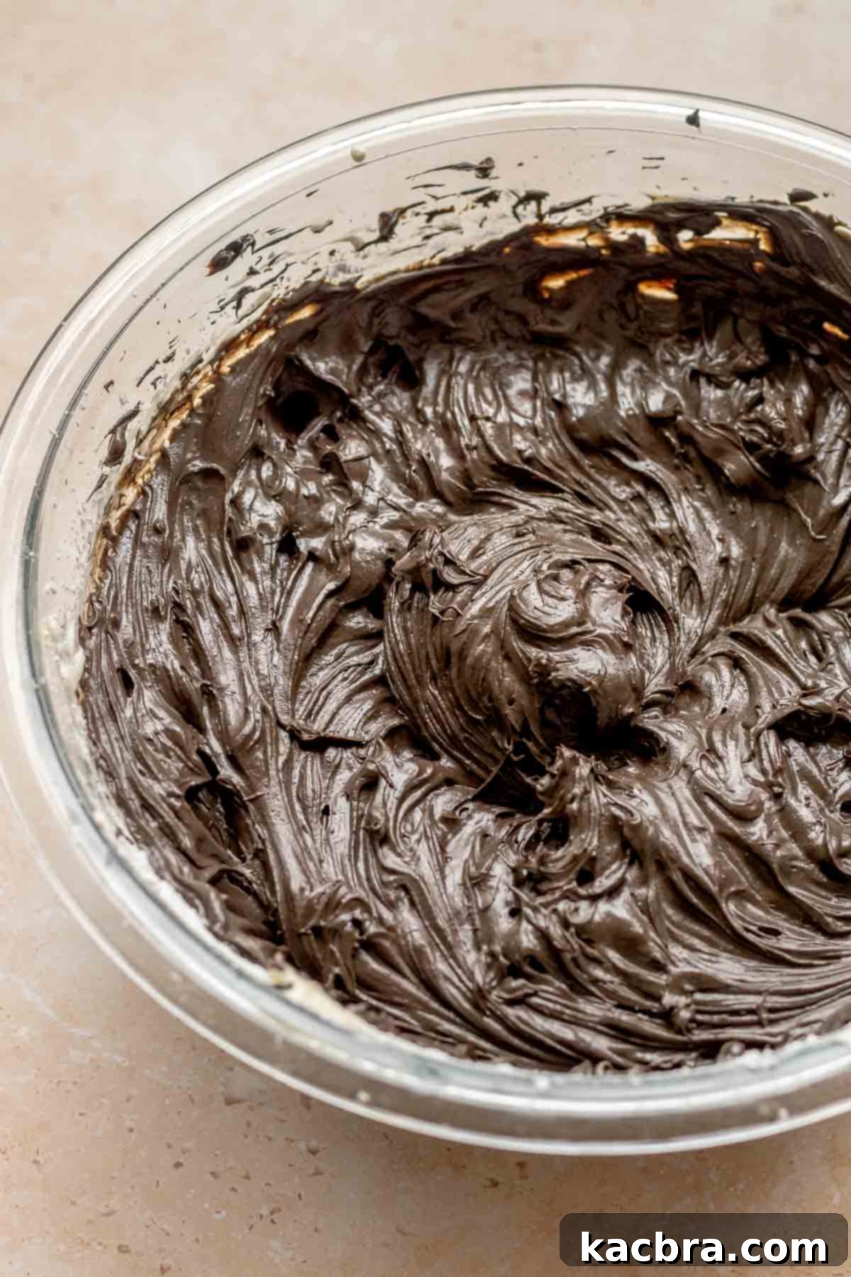 Black cheesecake batter in a bowl.