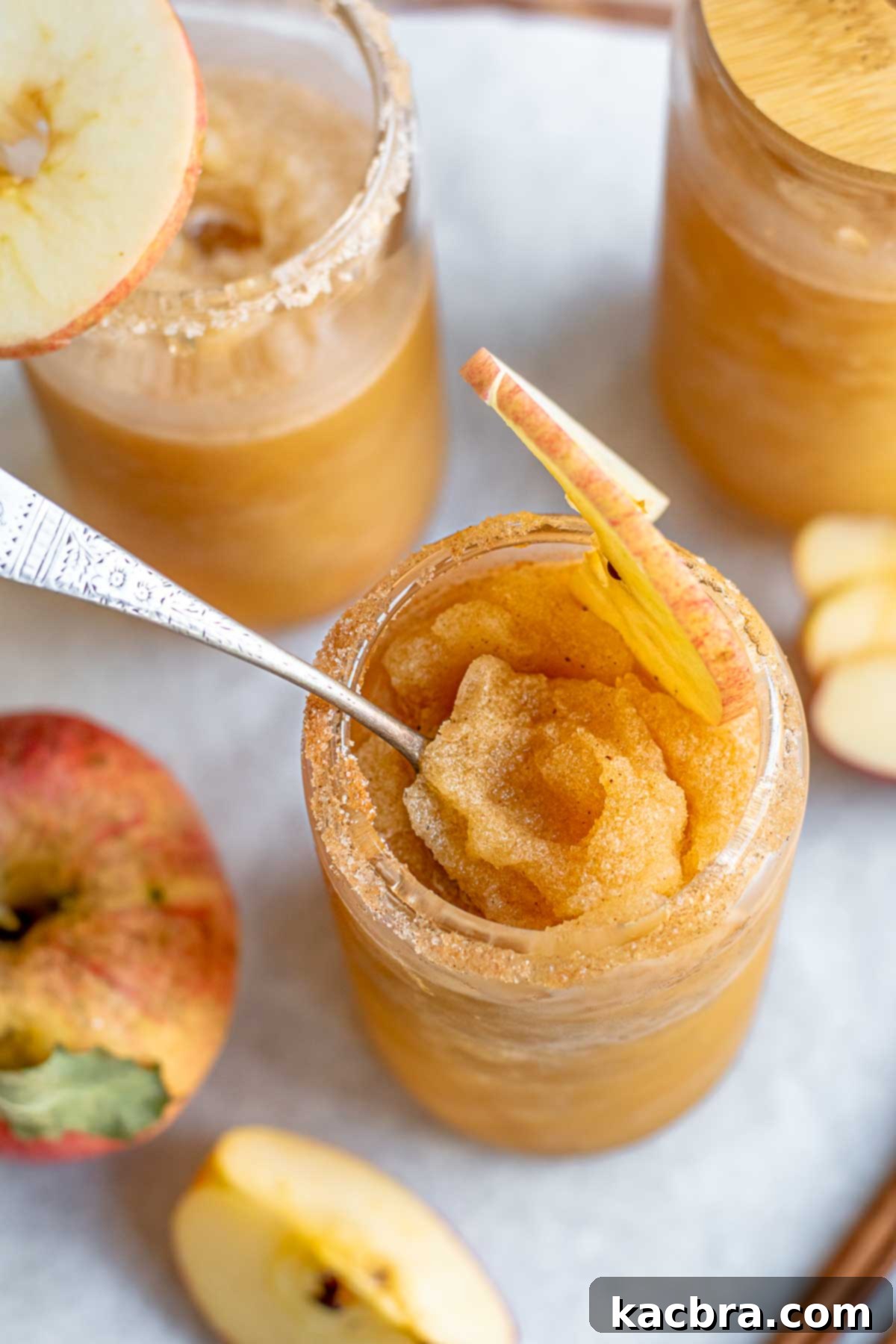 Spiced Apple Slush: Customize Your Cool 11 A spoon sits inside an apple cider slushie in a glass.