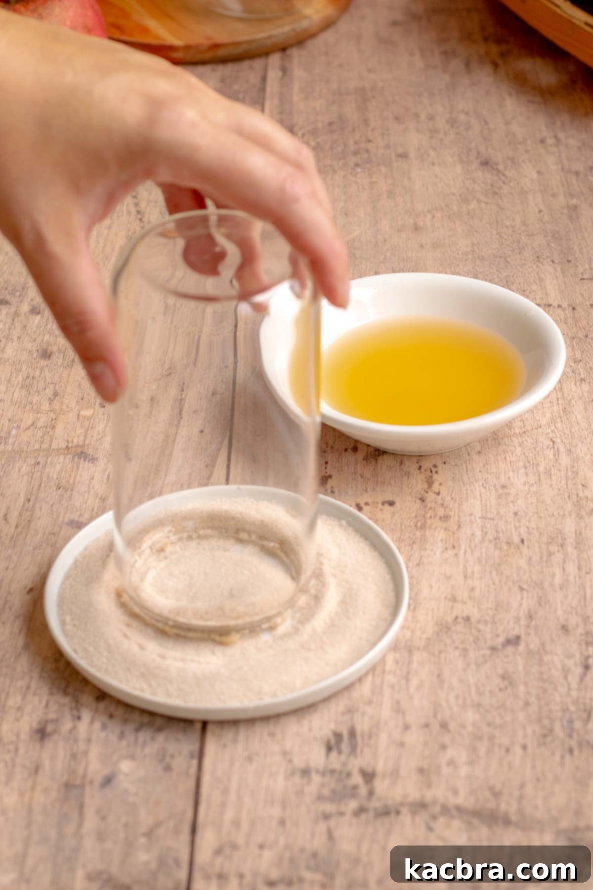 Spiced Apple Slush: Customize Your Cool 6 A hand dips the rim of a glass off into cinnamon sugar.