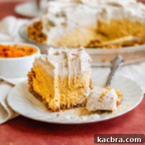 Creamy Pumpkin Cloud 13 A slice of pumpkin mousse pie on a plate with a fork taking a bite.
