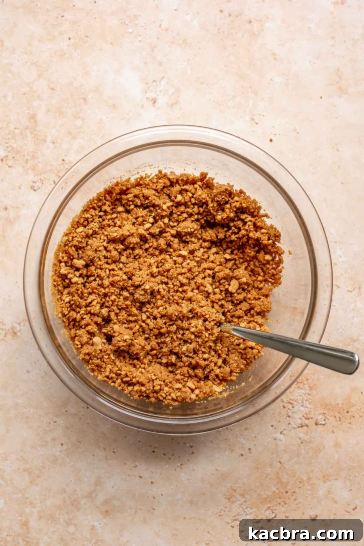 Creamy Pumpkin Cloud 4 Ginger snap cookie crumbs mixed with melted butter and salt in a bowl, ready to form the pie crust.