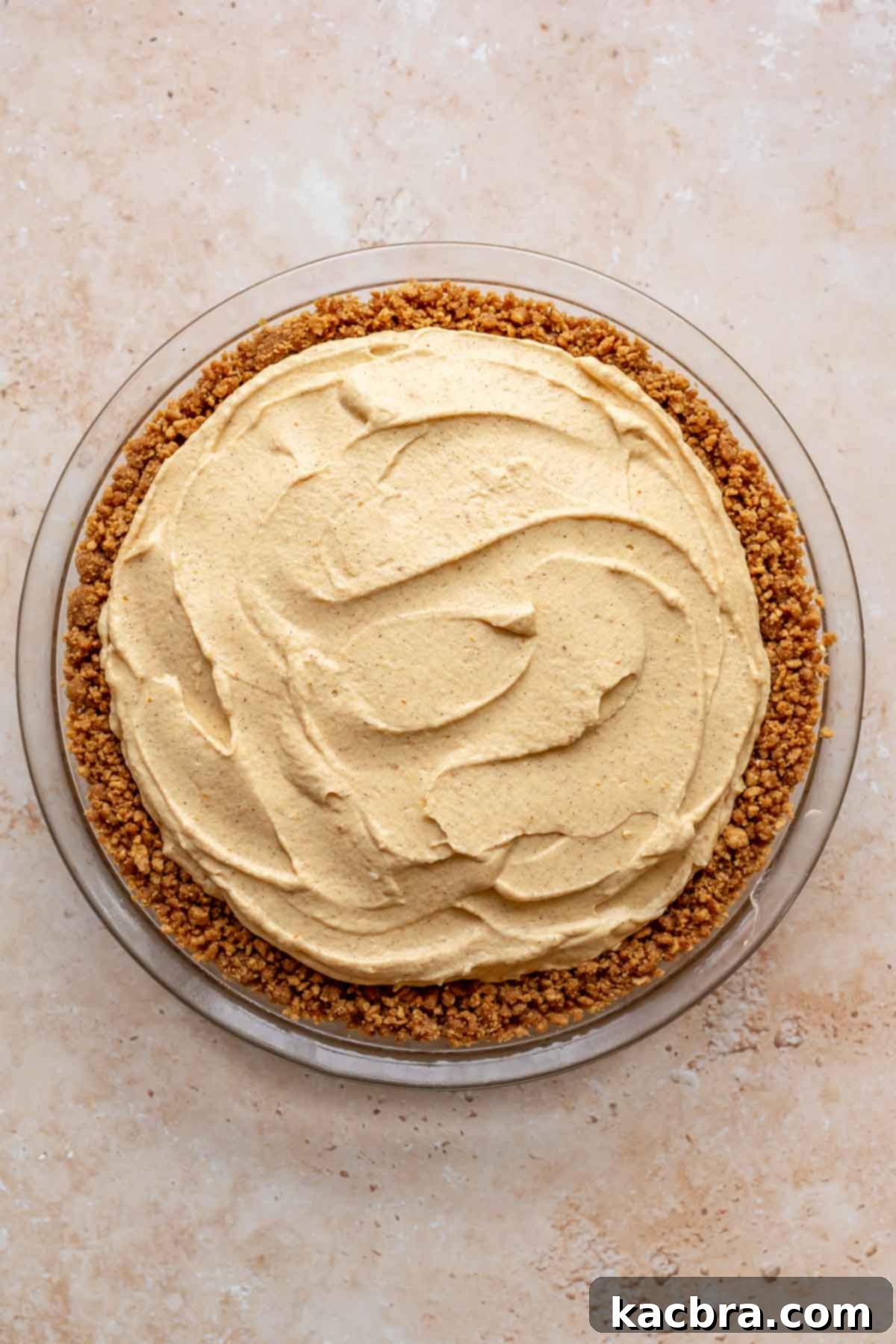 Creamy Pumpkin Cloud 10 The smooth, light pumpkin mousse filling spread evenly into the chilled gingersnap crust in a pie dish.