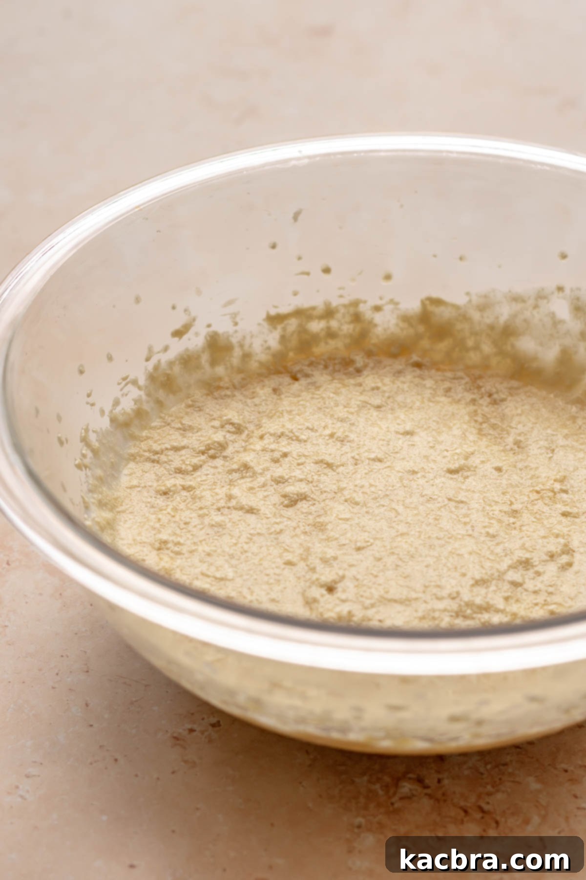 Golden Honey Baklava Dream Cake 13 Cake batter in a bowl, appearing slightly curdled after adding buttermilk.