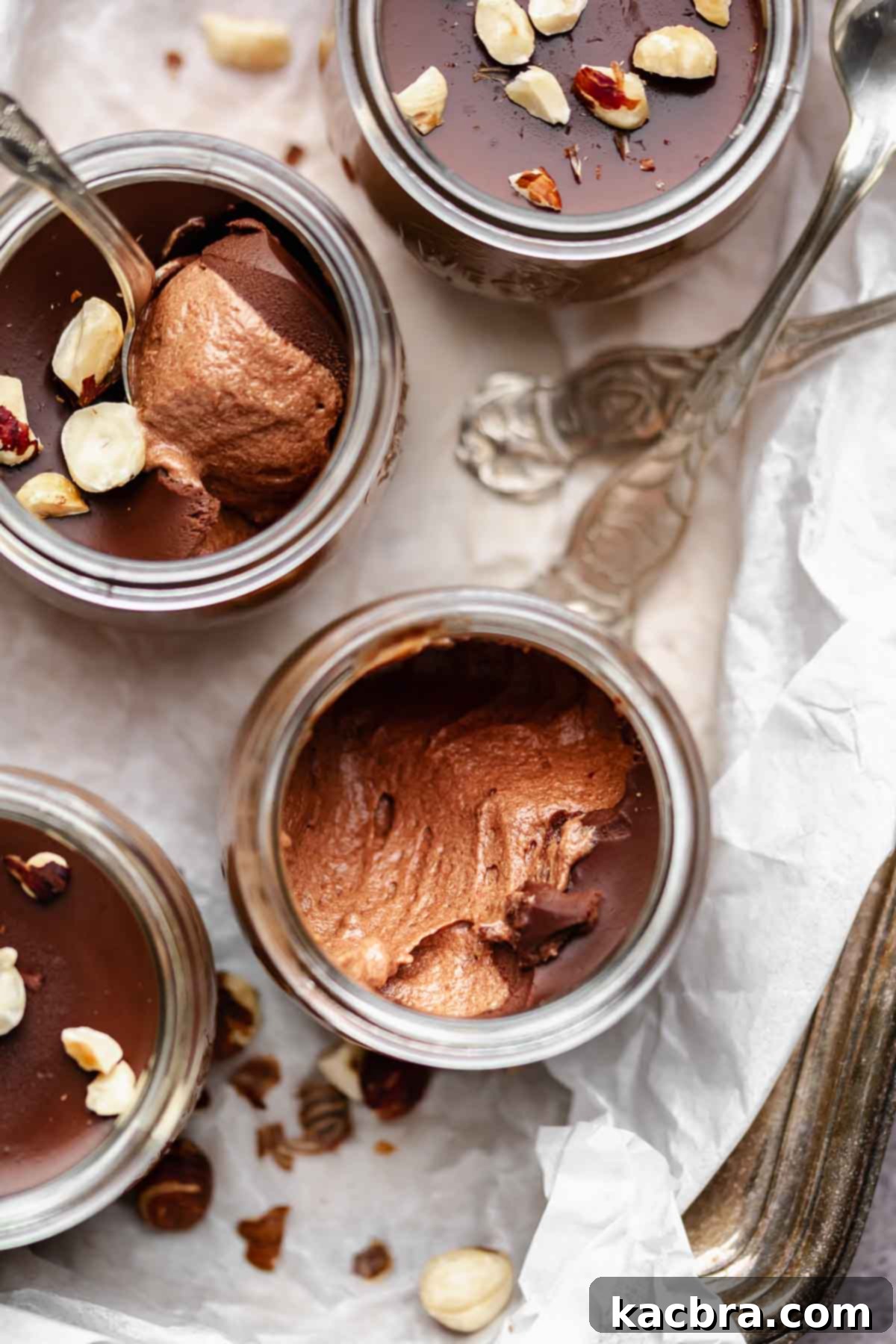 Nutella mousse cups on platter with spoons,.