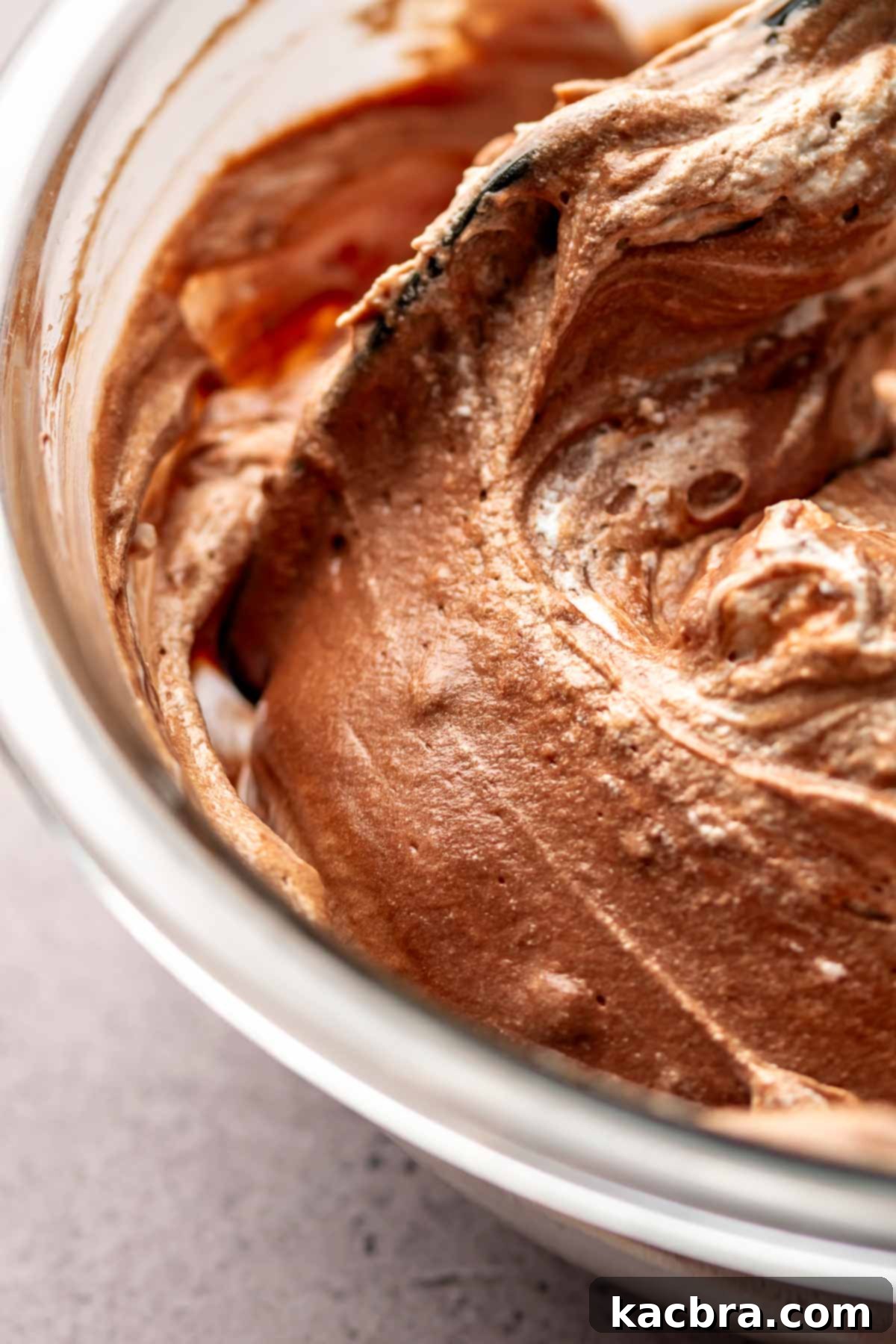 Egg whites being folded into chocolate mixture.