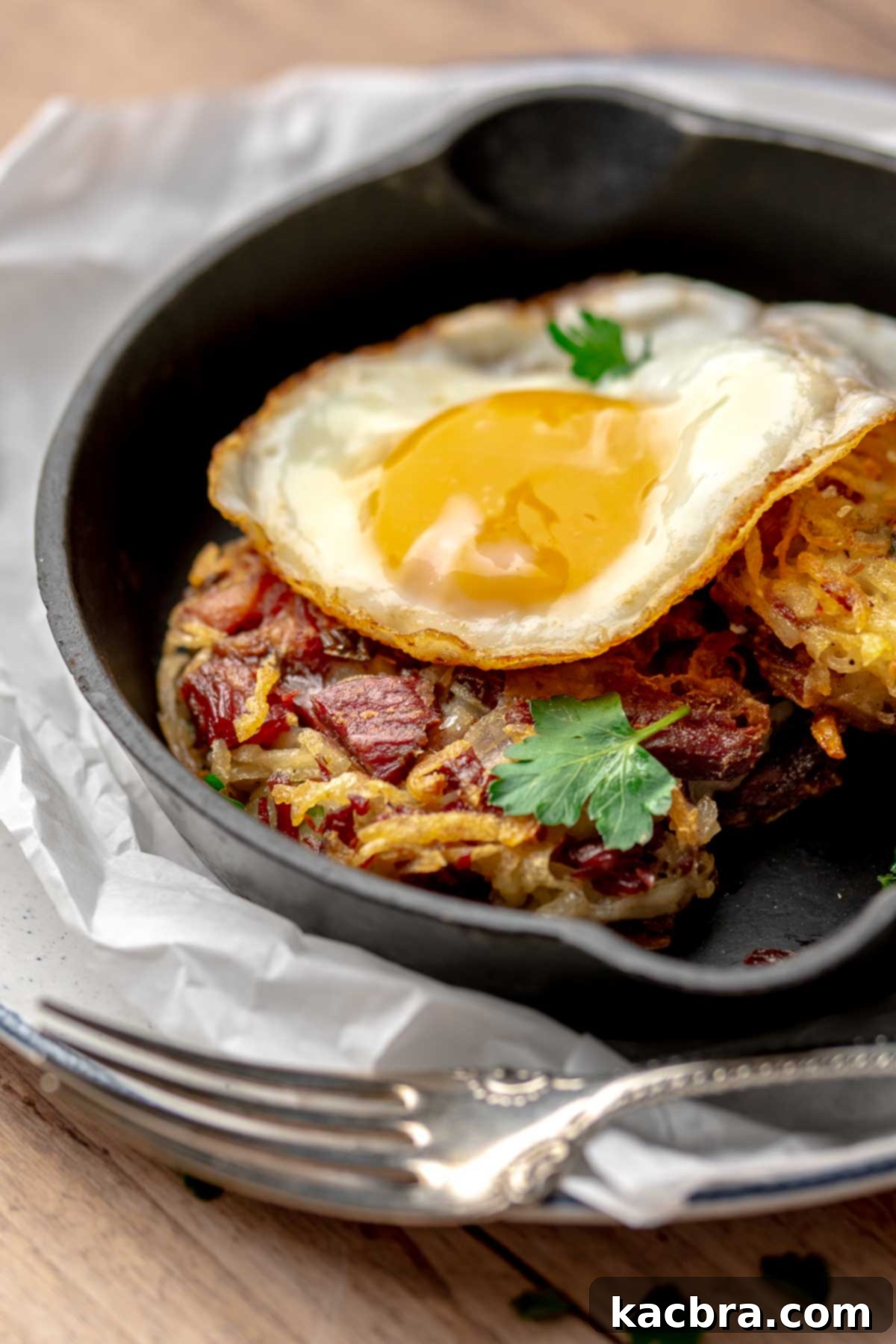 Corned beef fritter with a fried egg on top.