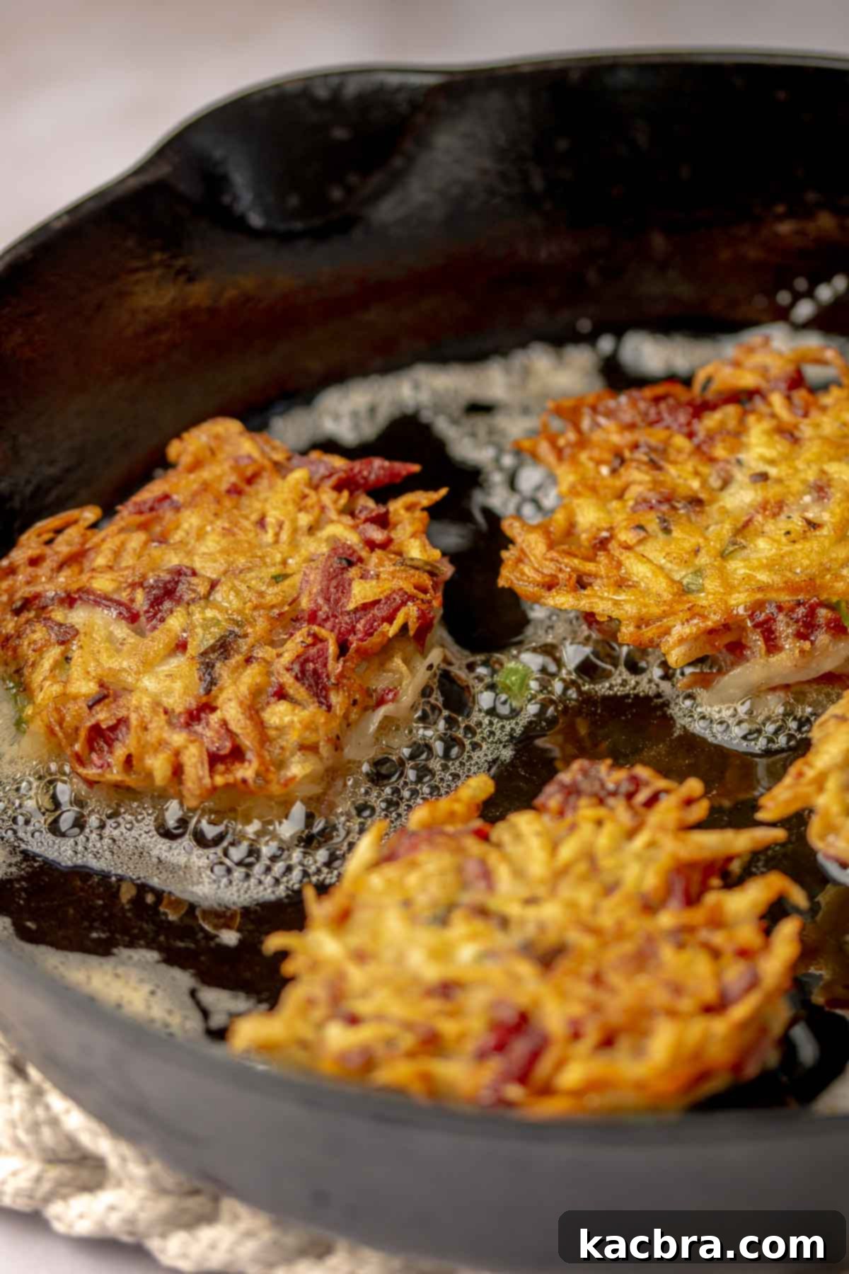 Corned beef fritters frying in oil.