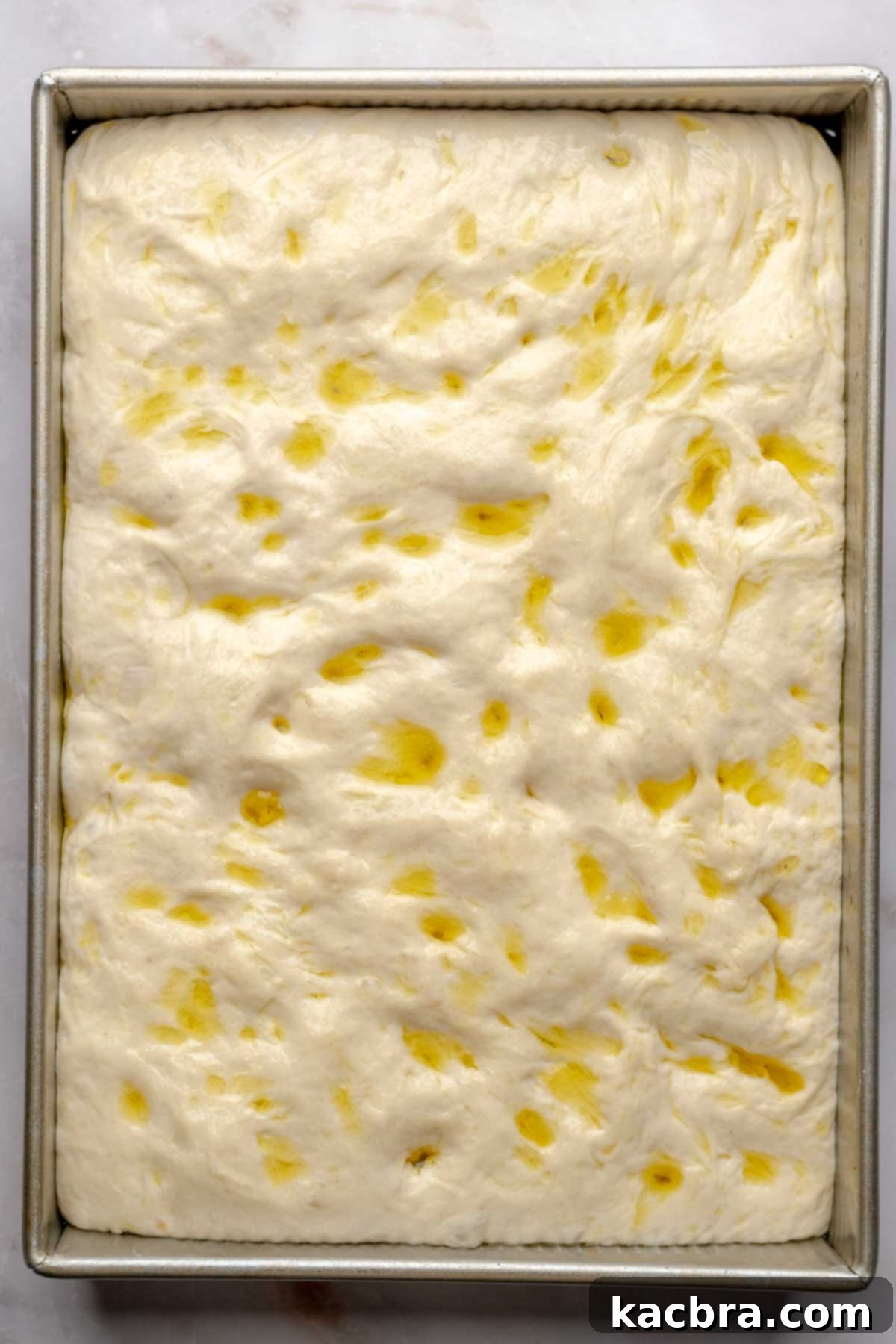 Aromatic Pesto Focaccia 13 Risen focaccia dough filling the pan.