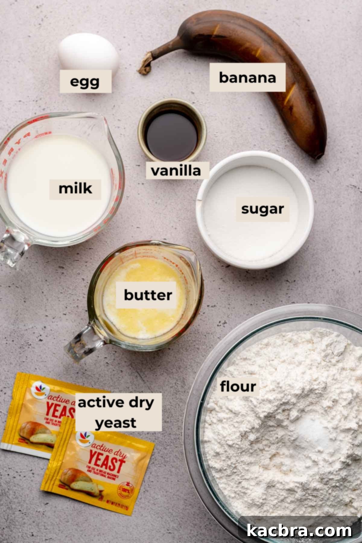 A collection of dry ingredients including flour, sugar, and yeast, neatly arranged for making banana cinnamon rolls.