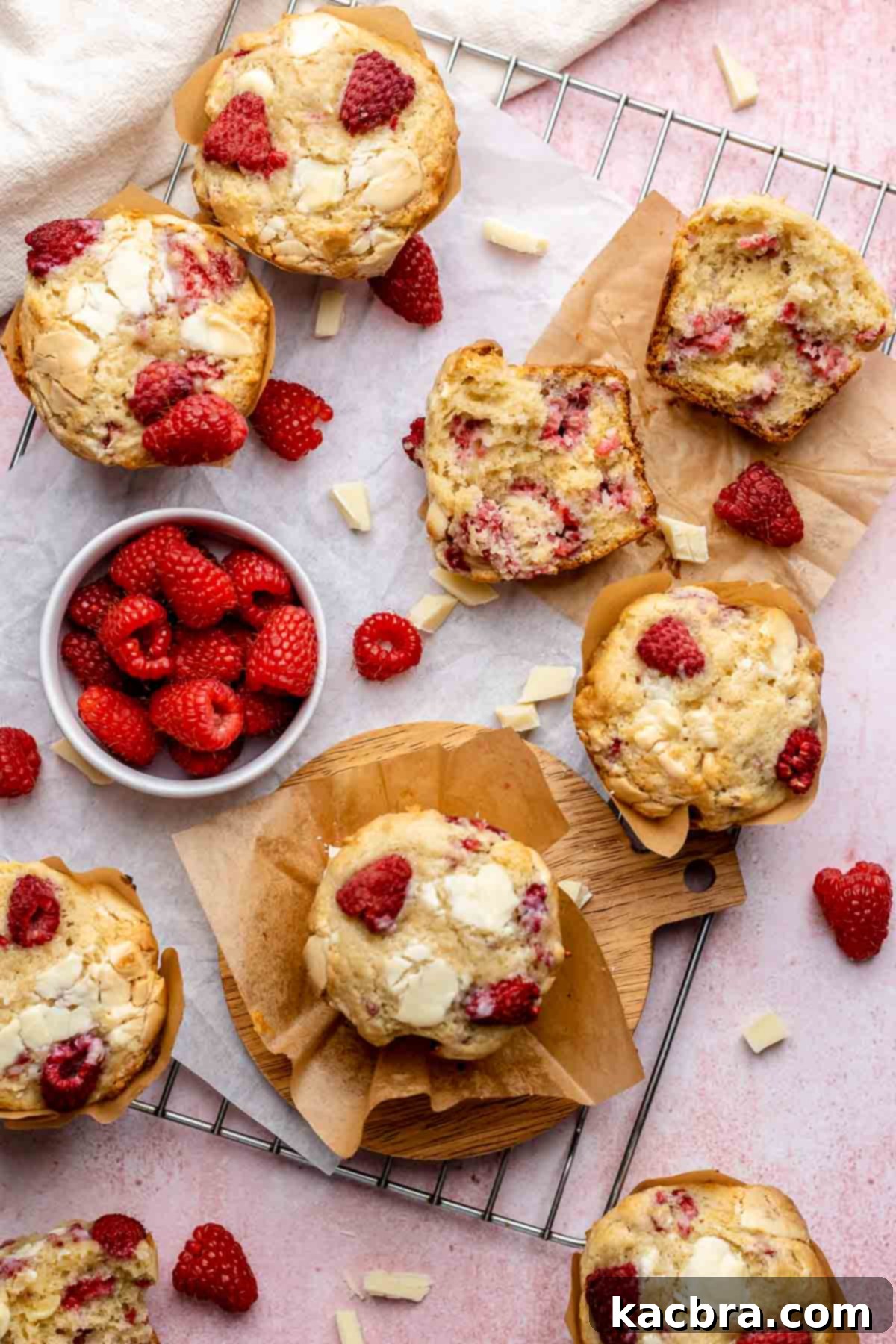 A charming scattering of freshly baked raspberry white chocolate muffins, showcasing their golden-brown tops and inviting texture.
