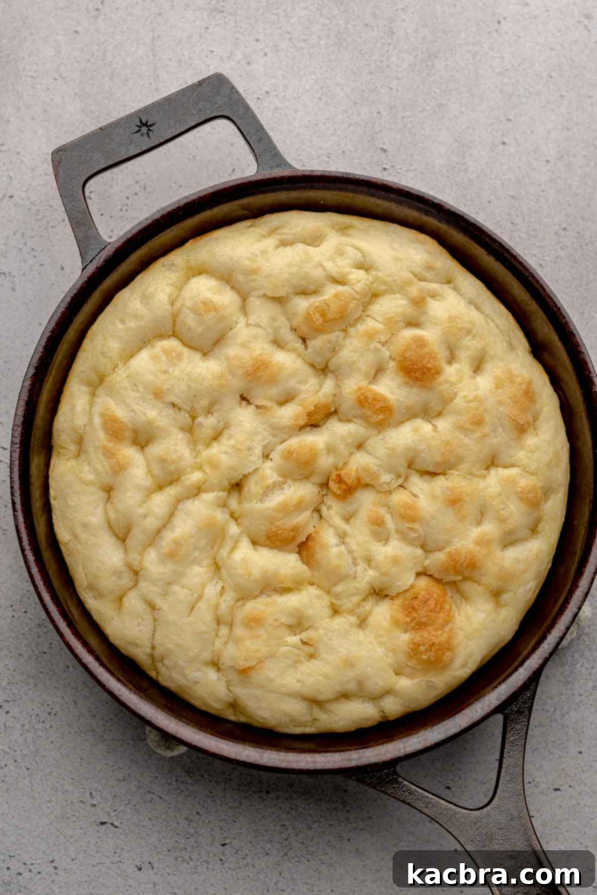 Par baked pizza dough in a cast iron pan.