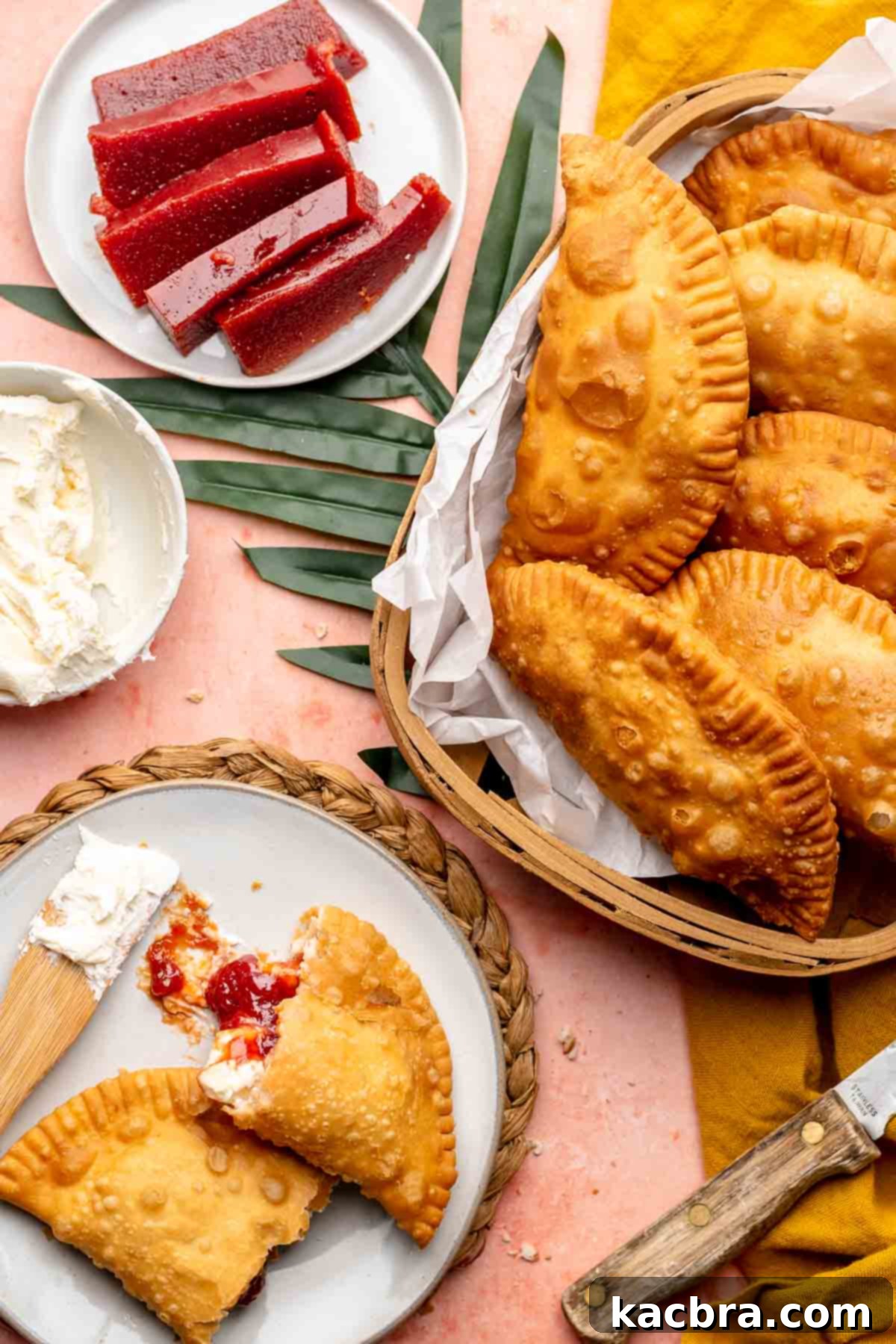 Guava empanadas in a basket and one on a plate next to it.