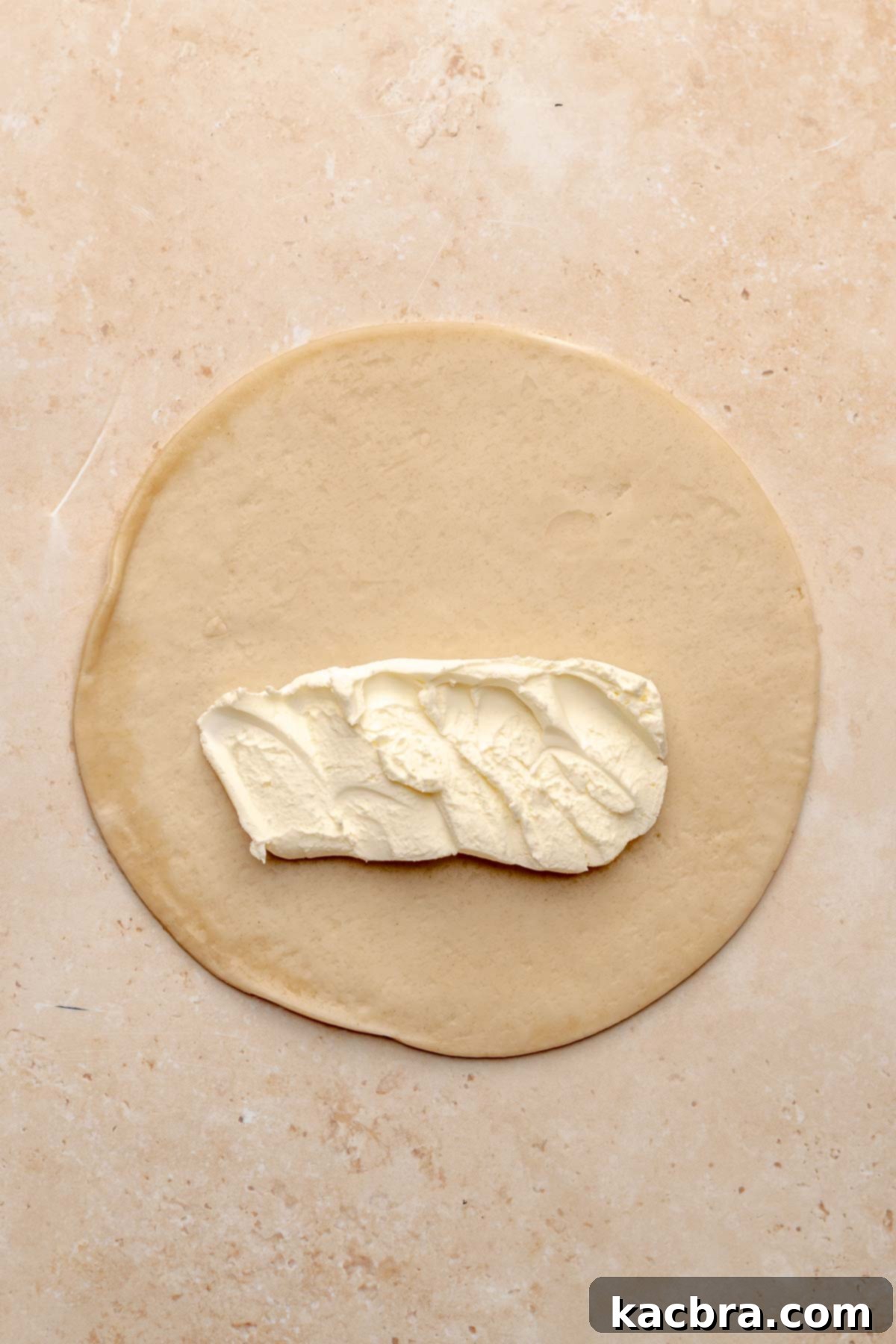 A strip of cream cheese in the center of an empanada sic.