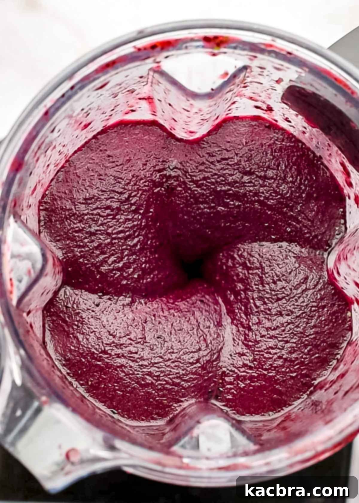 Blueberry sorbet being blended in a blender.