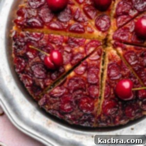 Sliced cherry upside down cake on a platter, ready to be served.