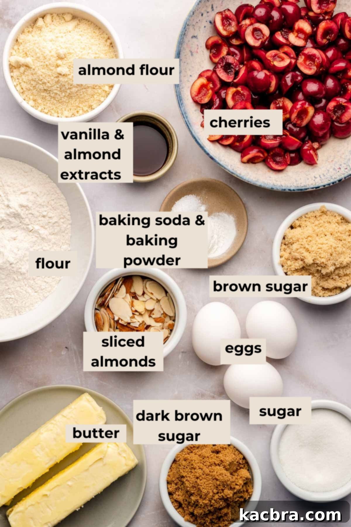 Ingredients for cherry upside down cake, laid out on a wooden surface.