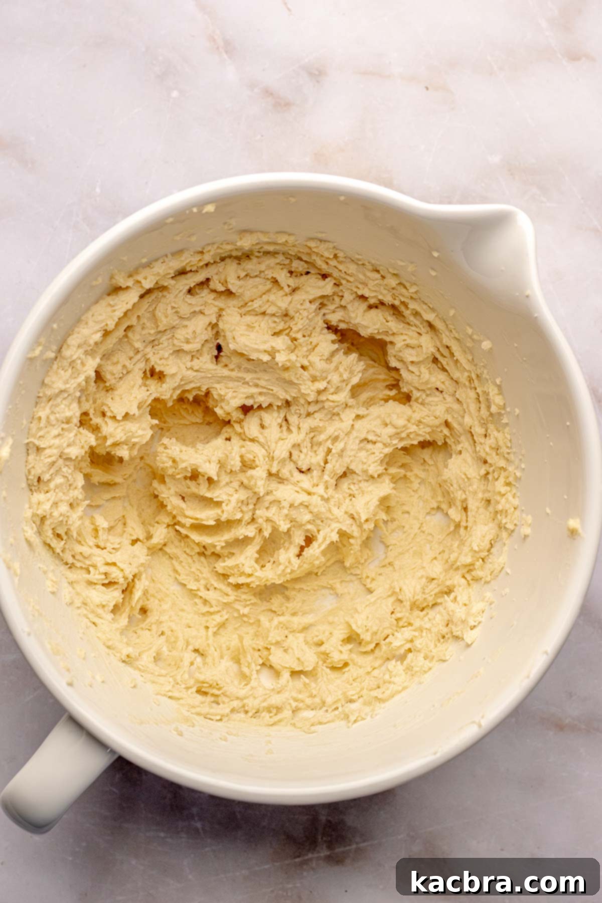 Creamed butter and sugar in a mixing bowl for the cake batter.