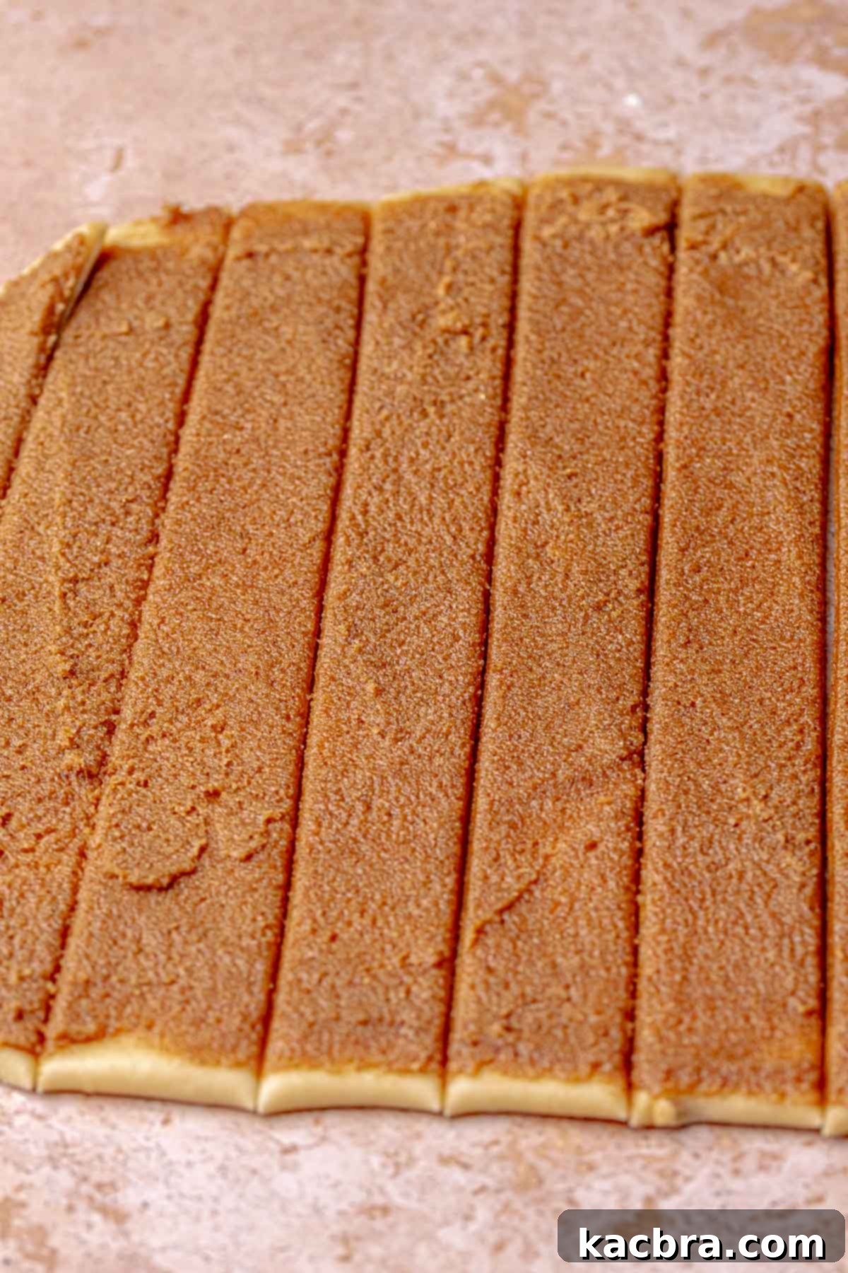 Cut strips of cinnamon roll dough.