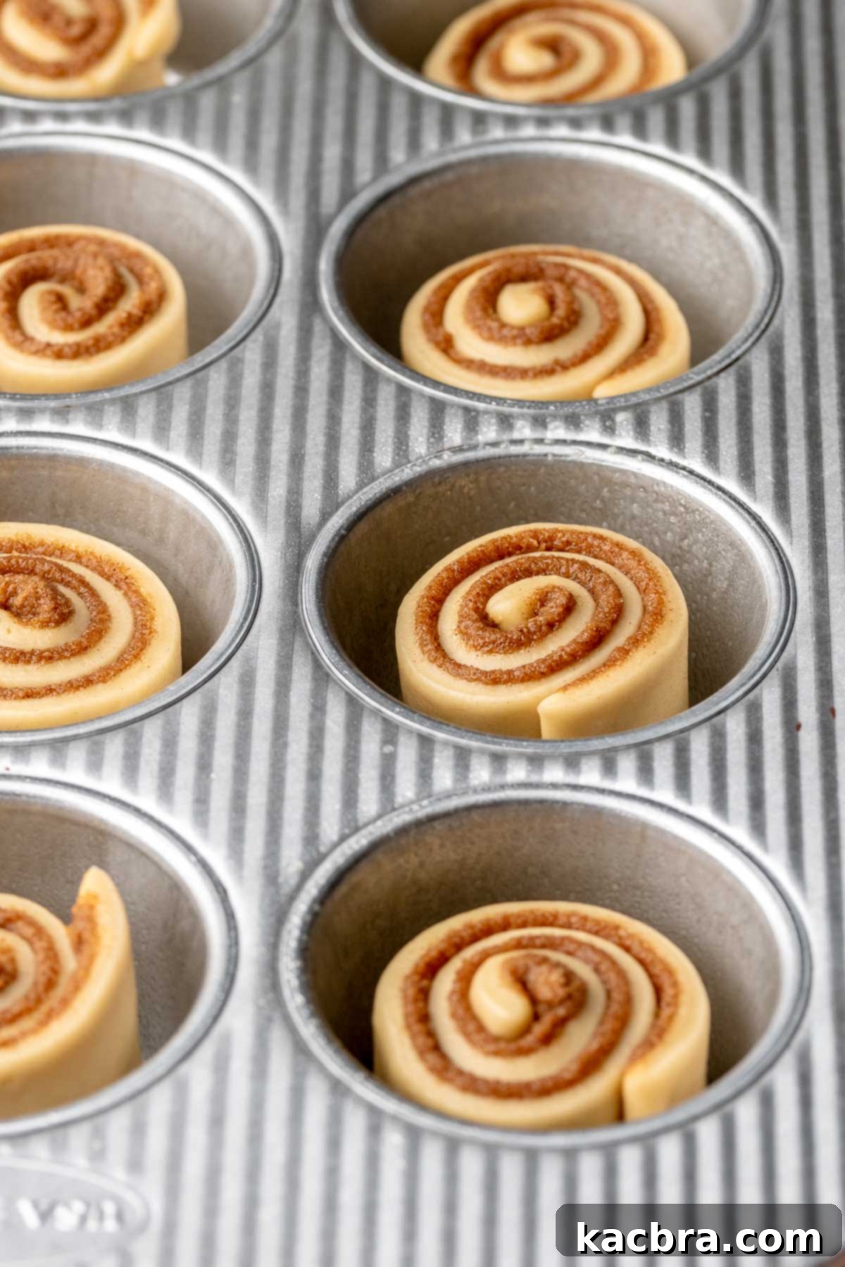 Pre baked, pre-rised mini cinnamon rolls in a muffin tin.