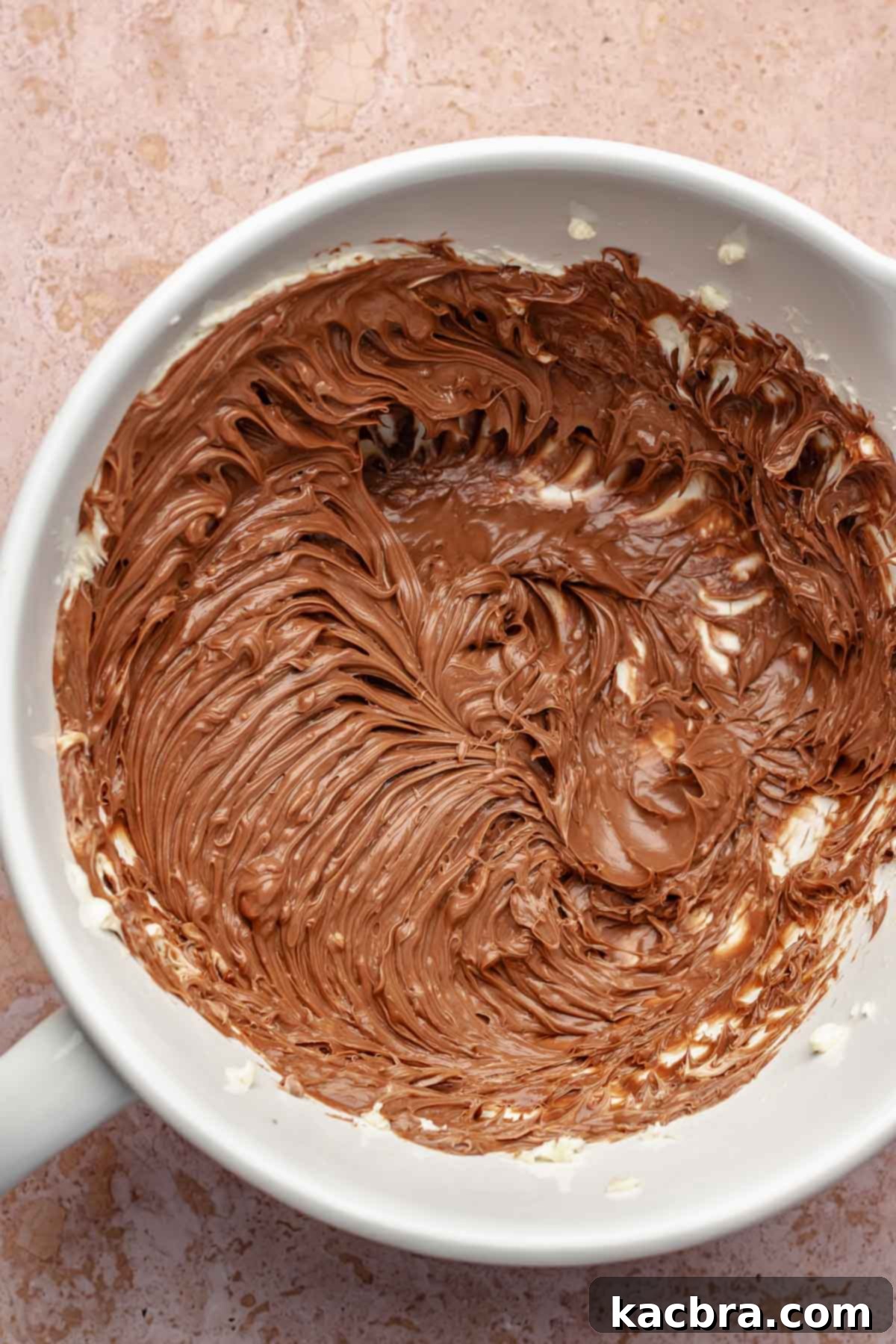 Creamed butter and nutella in a bowl.