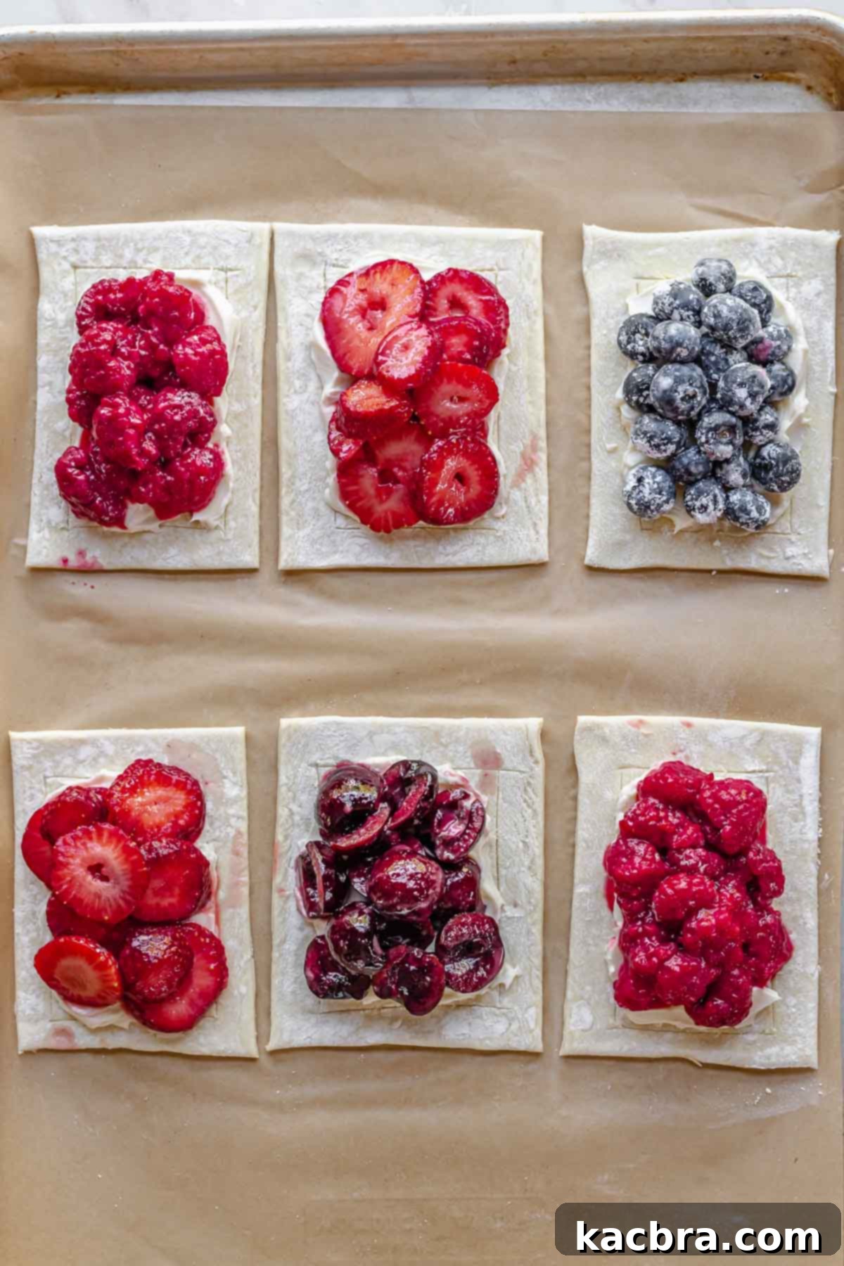 Pre-baked fruit and cream cheese danishes ready to be baked.