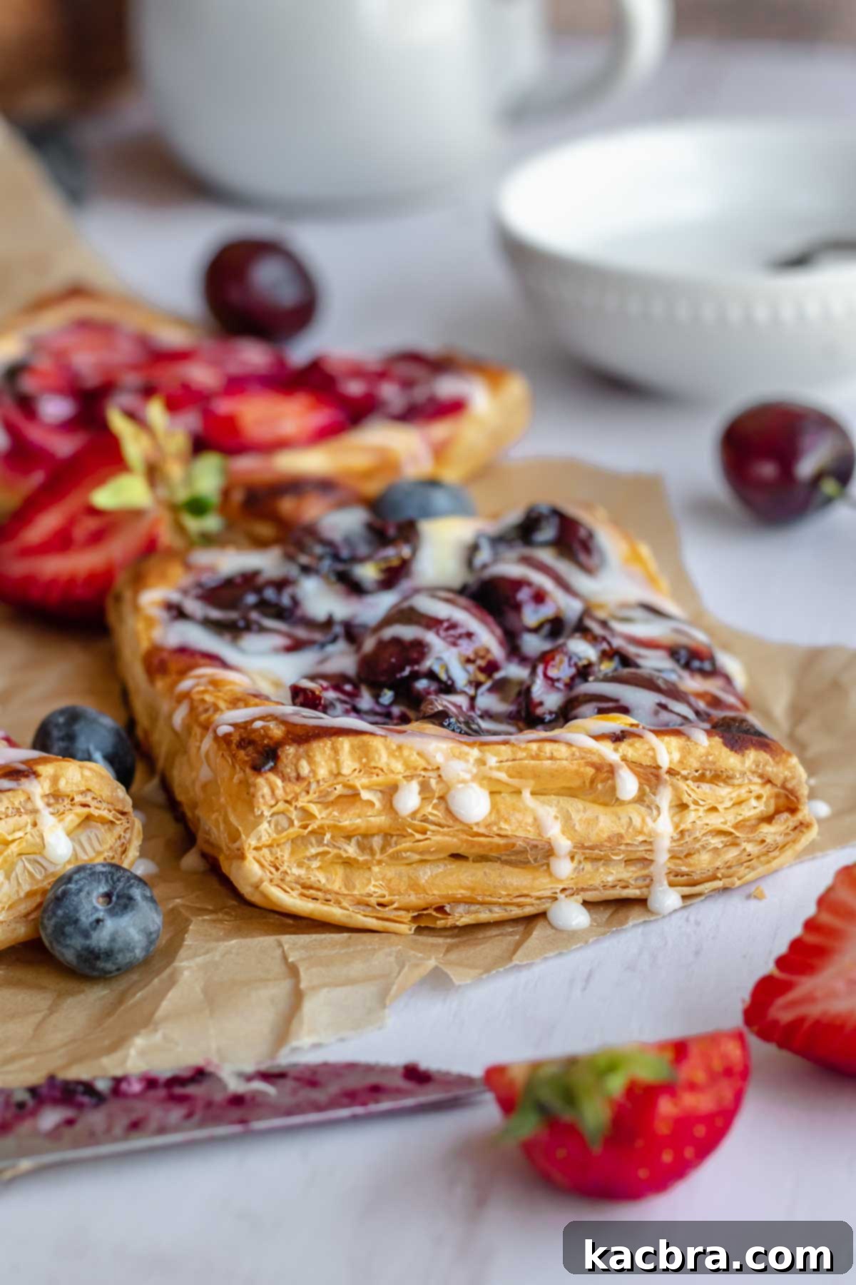 A blueberry cream cheese danish topped with vanilla icing.