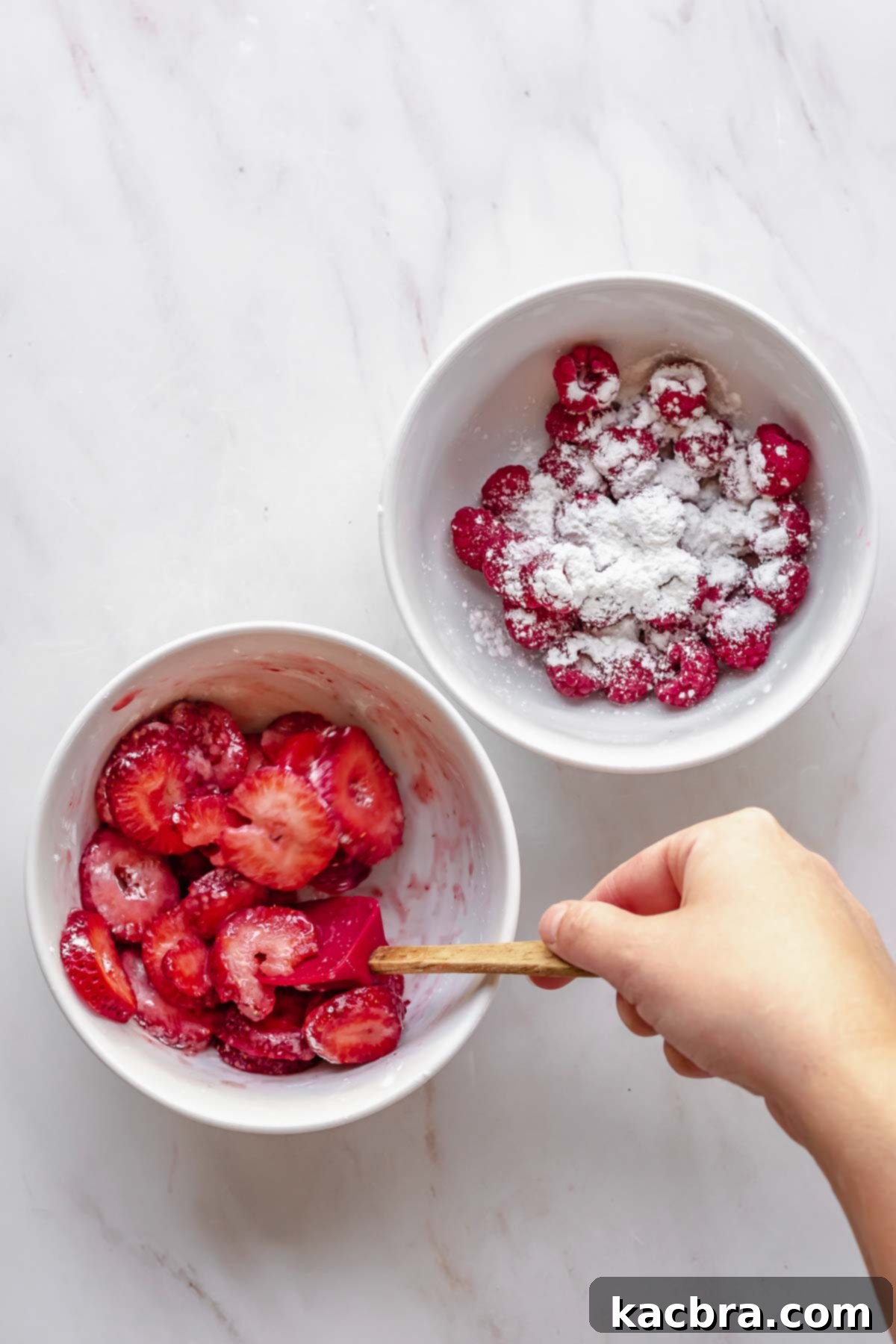 A spatula mixes fruit and cornstarch in bowls.