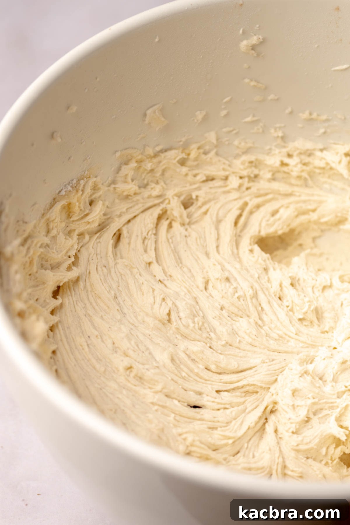 Warm Cornbread Cookies with Whipped Honey Butter 13 Smooth, creamy honey buttercream frosting in a bowl, ready for application.