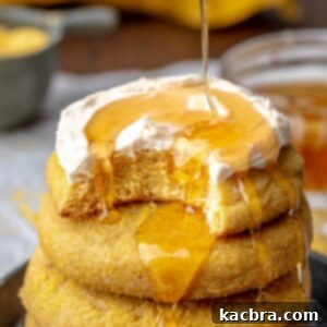 Warm Cornbread Cookies with Whipped Honey Butter 16 Honey being drizzled onto a stack of cornbread cookies, showcasing the final delicious touch.