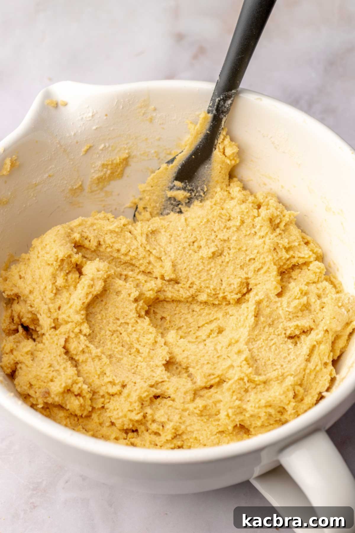 Warm Cornbread Cookies with Whipped Honey Butter 7 Thick cornbread cookie dough in a bowl, showing its rich texture and readiness for shaping.