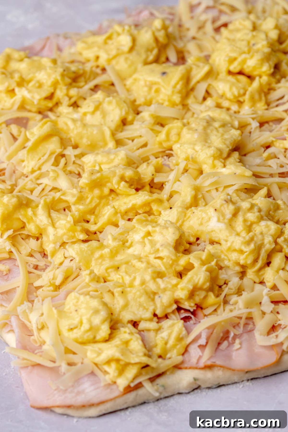 Fluffy Savory Rolls with Golden Hollandaise 12 Scrambled eggs layered over ham and shredded cheese on rolled-out dough.