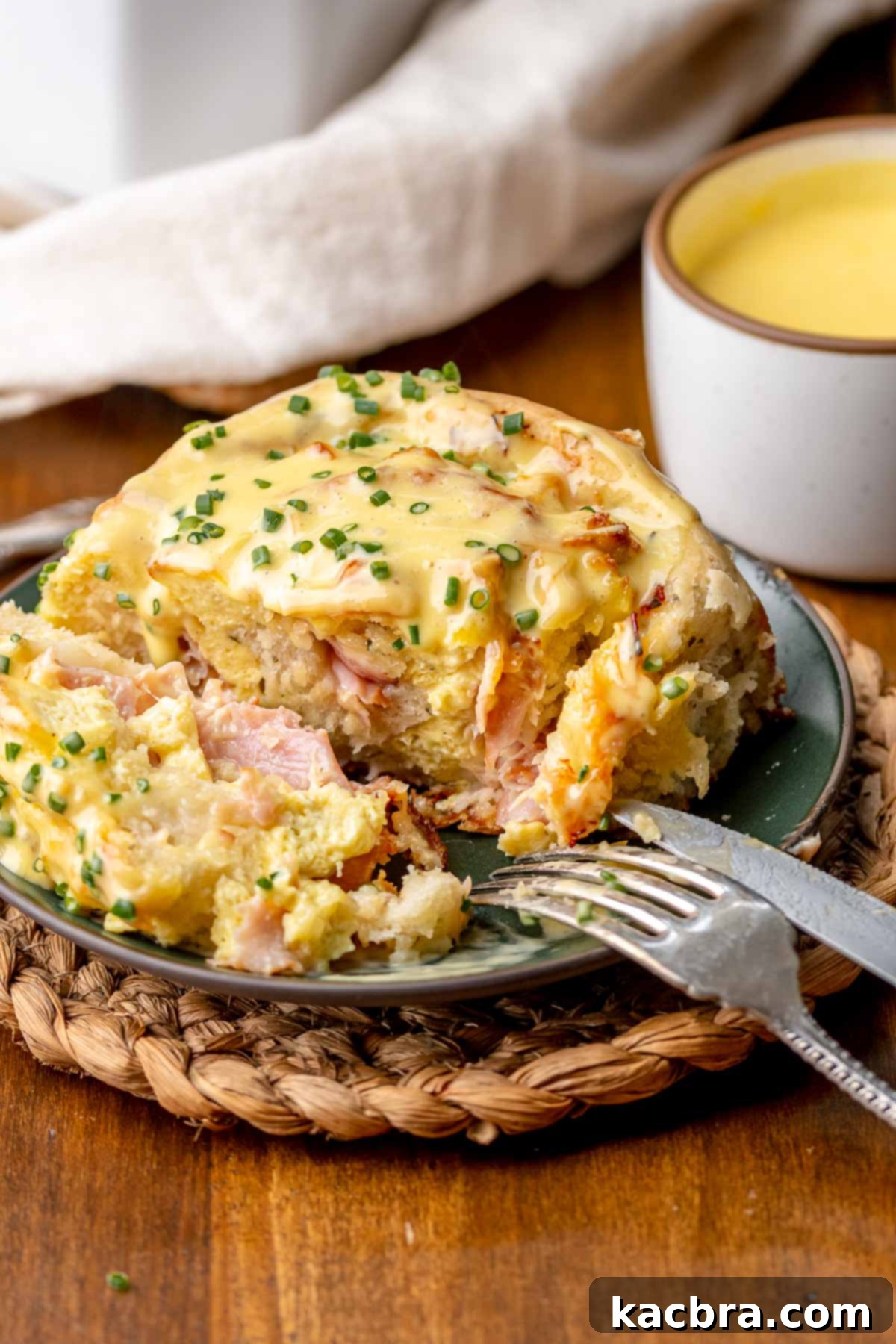 Fluffy Savory Rolls with Golden Hollandaise 18 A single savory roll cut open on a plate, revealing its delicious layers of eggs, cheese, and ham.