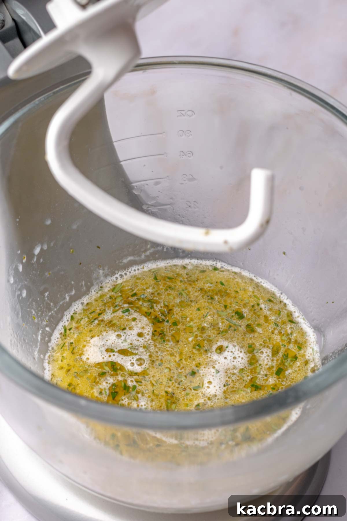 Fluffy Savory Rolls with Golden Hollandaise 6 Wet ingredients for bread dough in a bowl with a dough hook, with yeast activating.