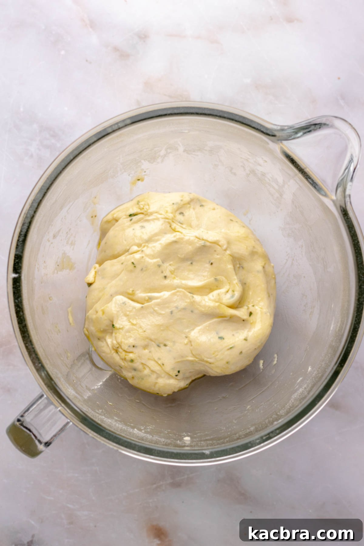 Fluffy Savory Rolls with Golden Hollandaise 8 Finished cinnamon roll dough resting in a greased bowl.