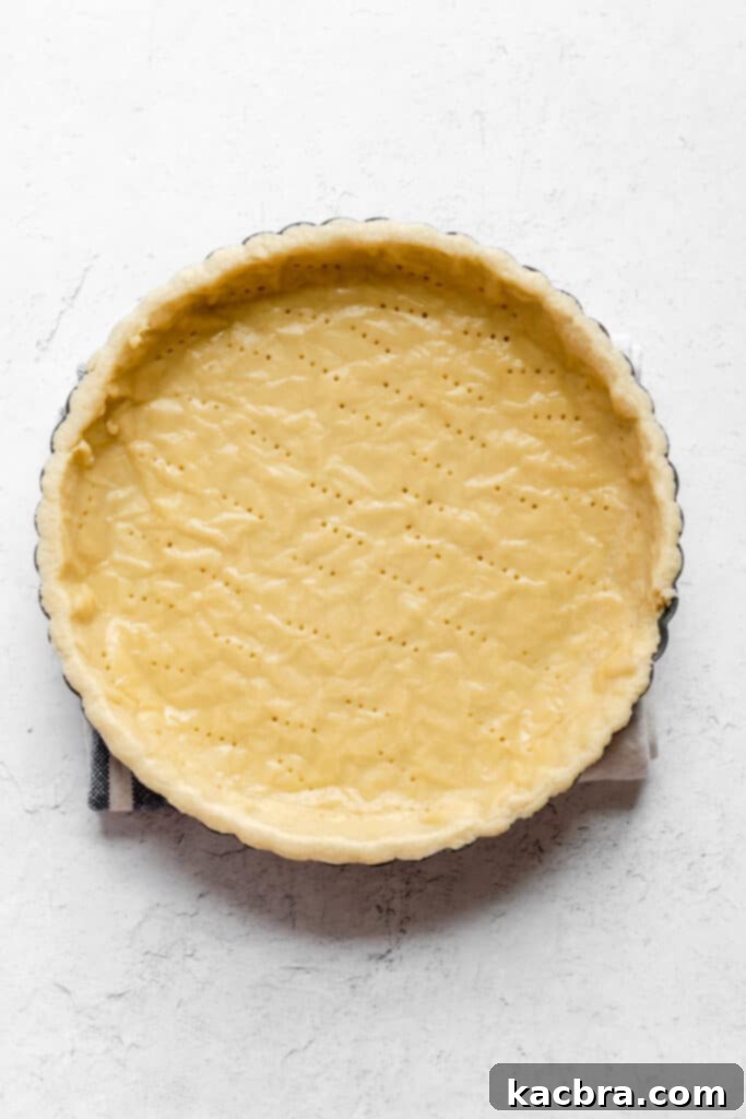 Fully blind-baked sweet tart crust resting on a wire rack to cool completely.