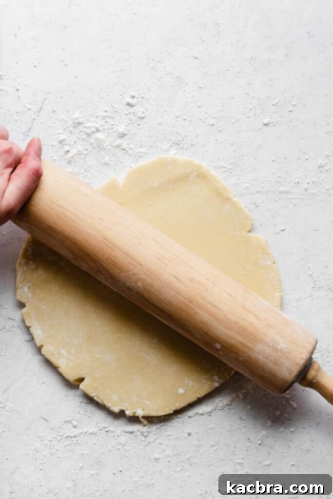 Adding an egg to the creamed butter and sugar mixture, ensuring proper emulsification.
