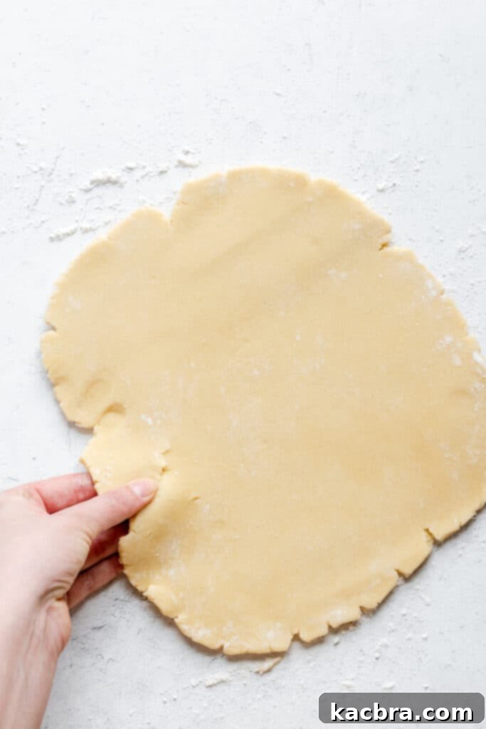 Adding all-purpose flour to the mixed wet ingredients to form the pâté sucrée dough.