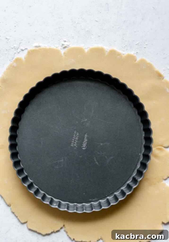 Finished pâté sucrée dough shaped into a uniform disk and securely wrapped in plastic wrap for chilling.