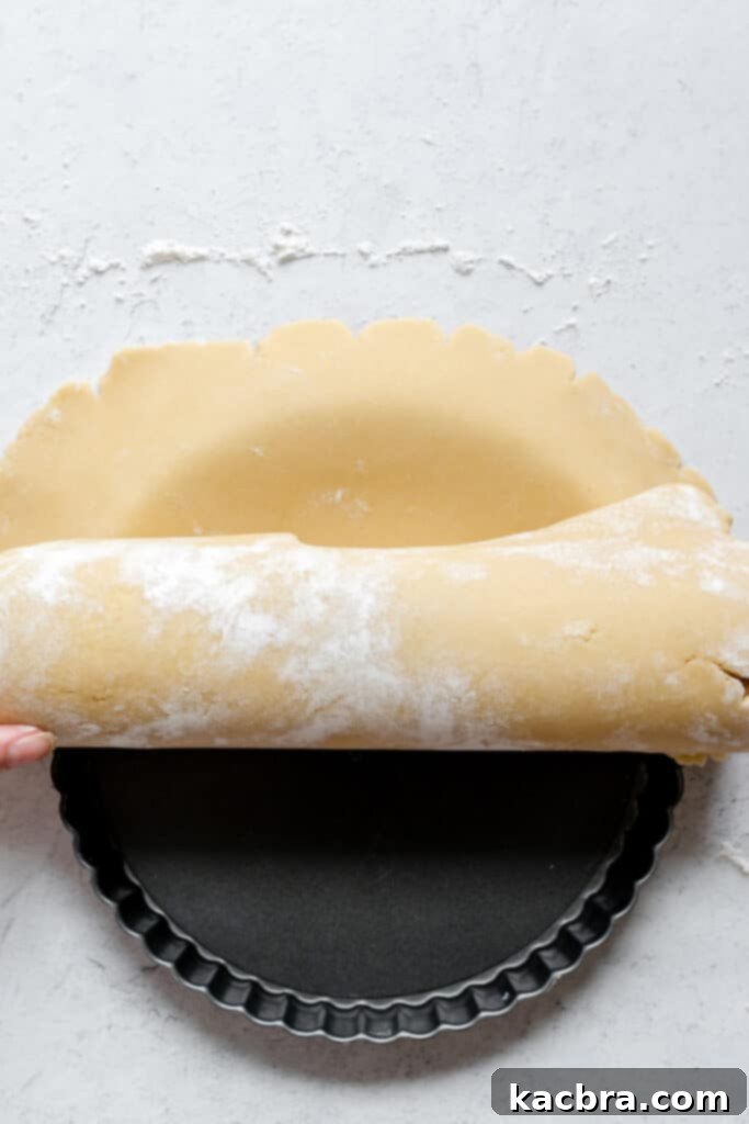 Gently pressing dough into the tart pan corners
