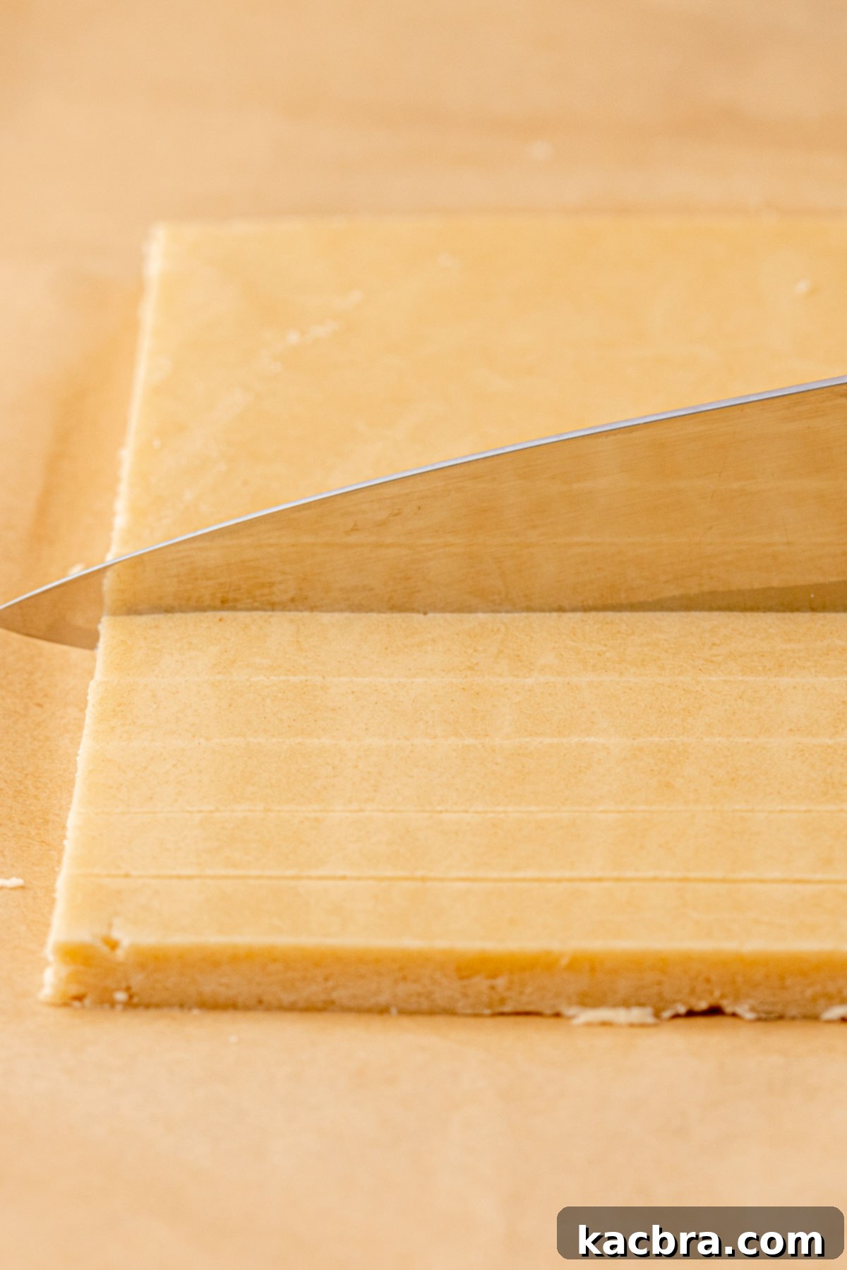 Irresistible Chocolate Cookie Dippers 12 A knife precisely cuts strips of chilled cookie dough to create individual cookie sticks.