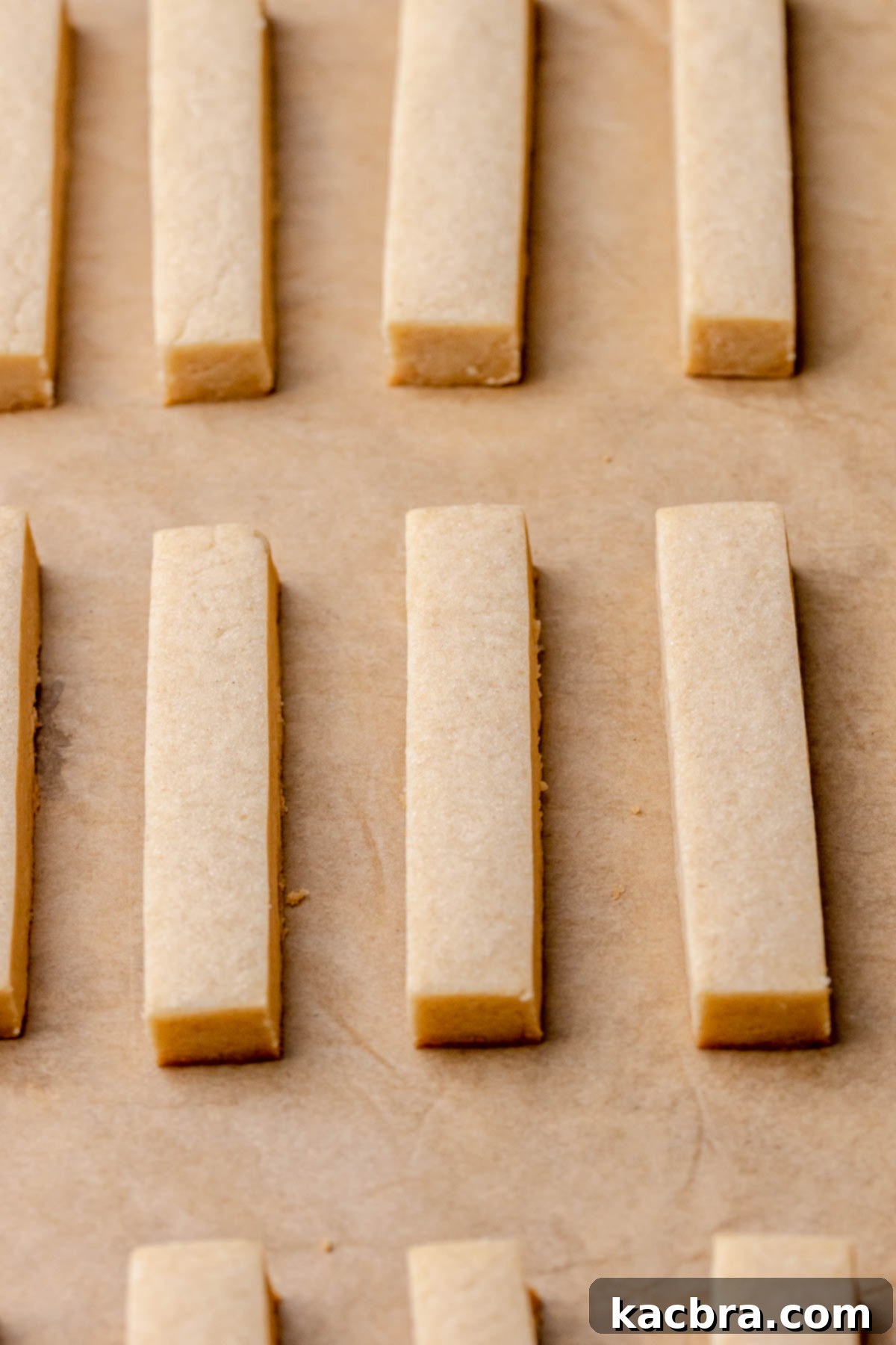 Irresistible Chocolate Cookie Dippers 15 Freshly baked cookie sticks on a baking pan, showing a light golden hue.