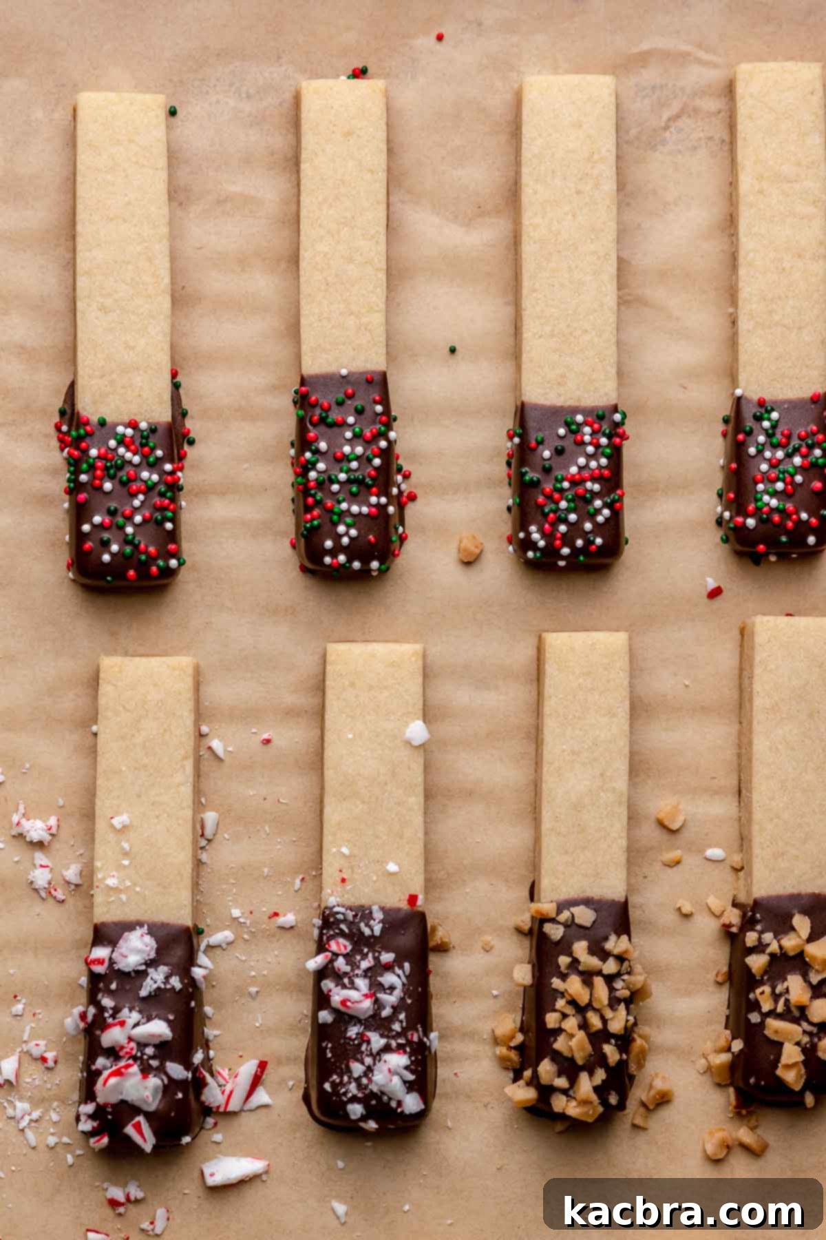 Chocolate Coated Cookie Wands 19 Decorated cookie sticks resting on parchment paper, allowing the chocolate to set completely.