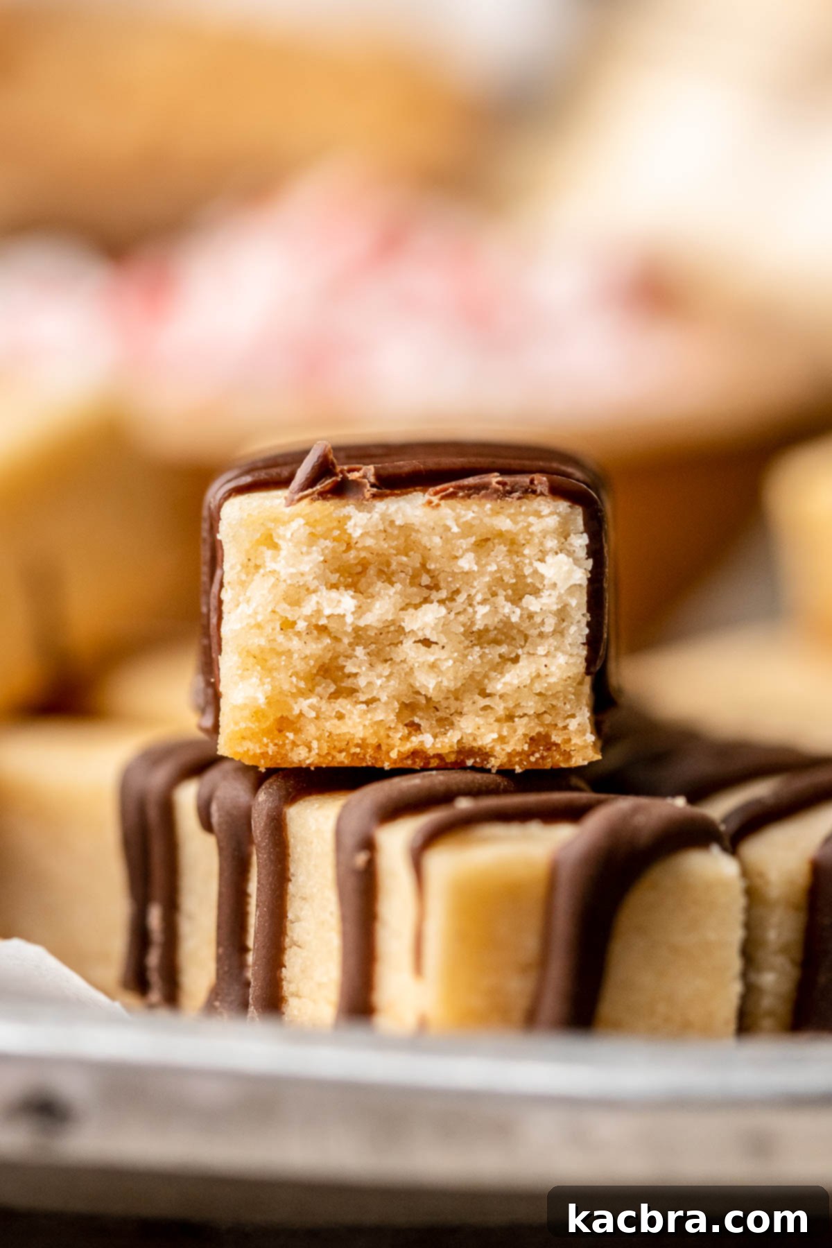 Chocolate Coated Cookie Wands 20 A cookie stick cut in half to show its buttery, tender center and chocolate coating.