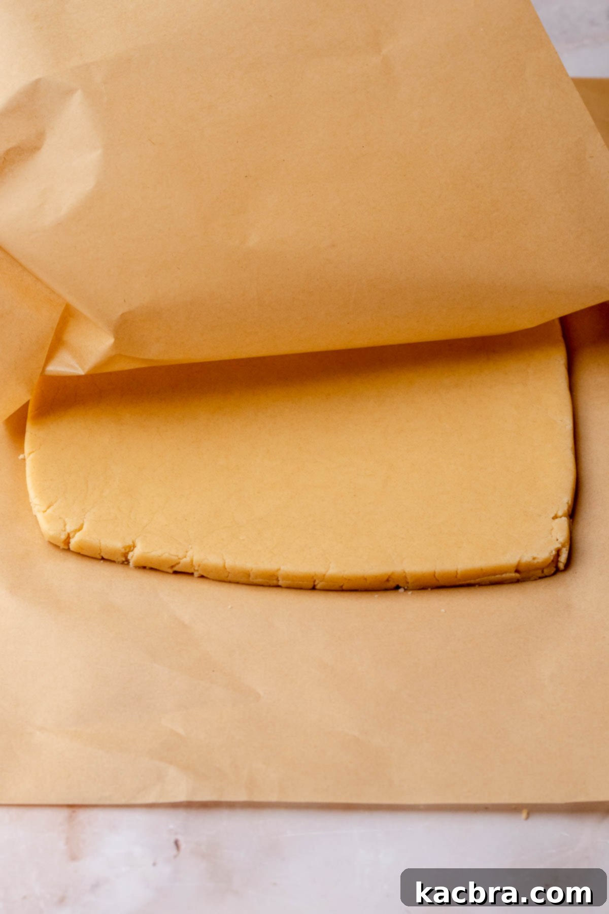 Irresistible Chocolate Cookie Dippers 10 Rolled out shortbread cookie dough, perfectly even, nestled between two pieces of parchment paper.