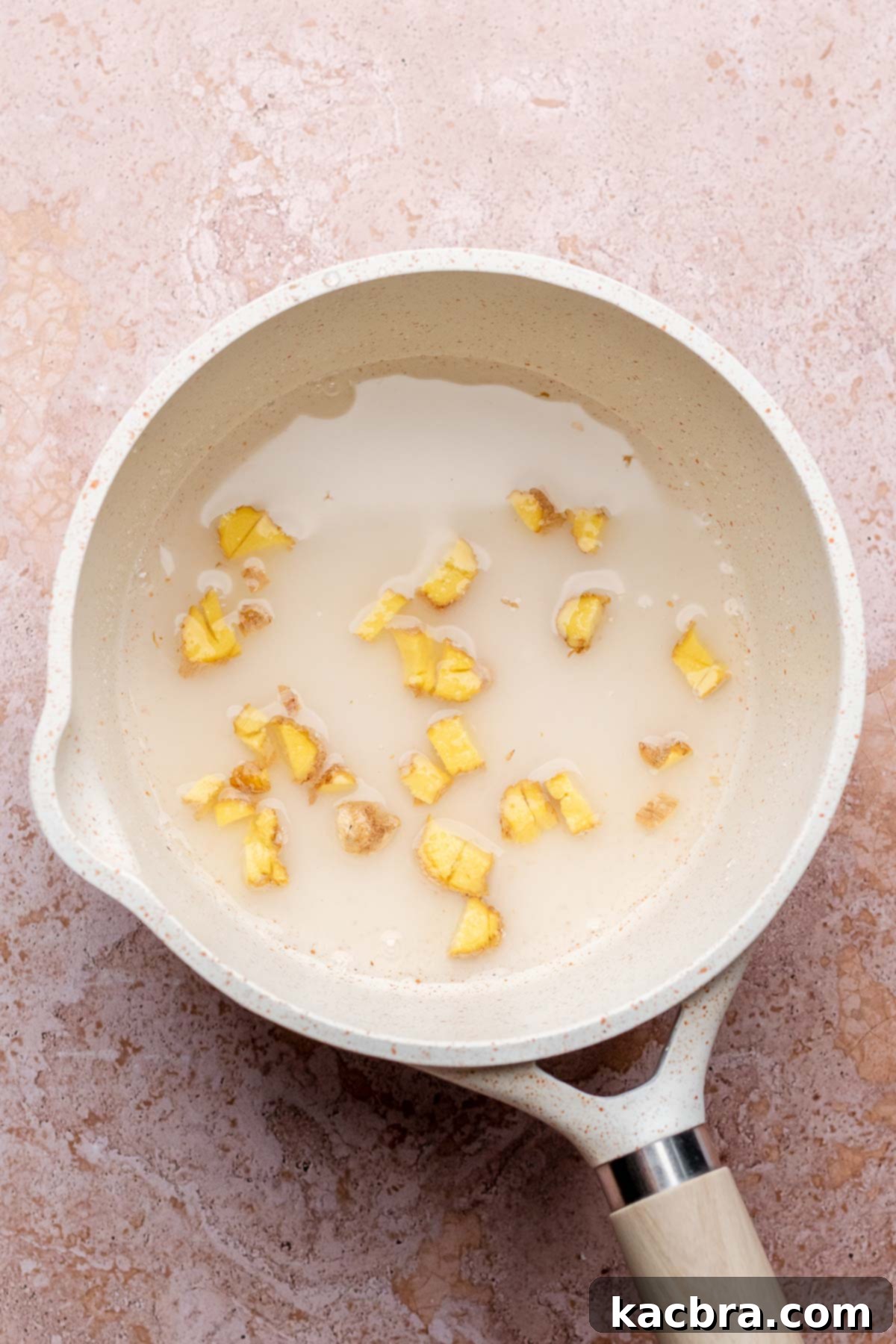 Pear-Kissed Chocolate Cake 10 Ginger pieces with water and sugar in a saucepan.